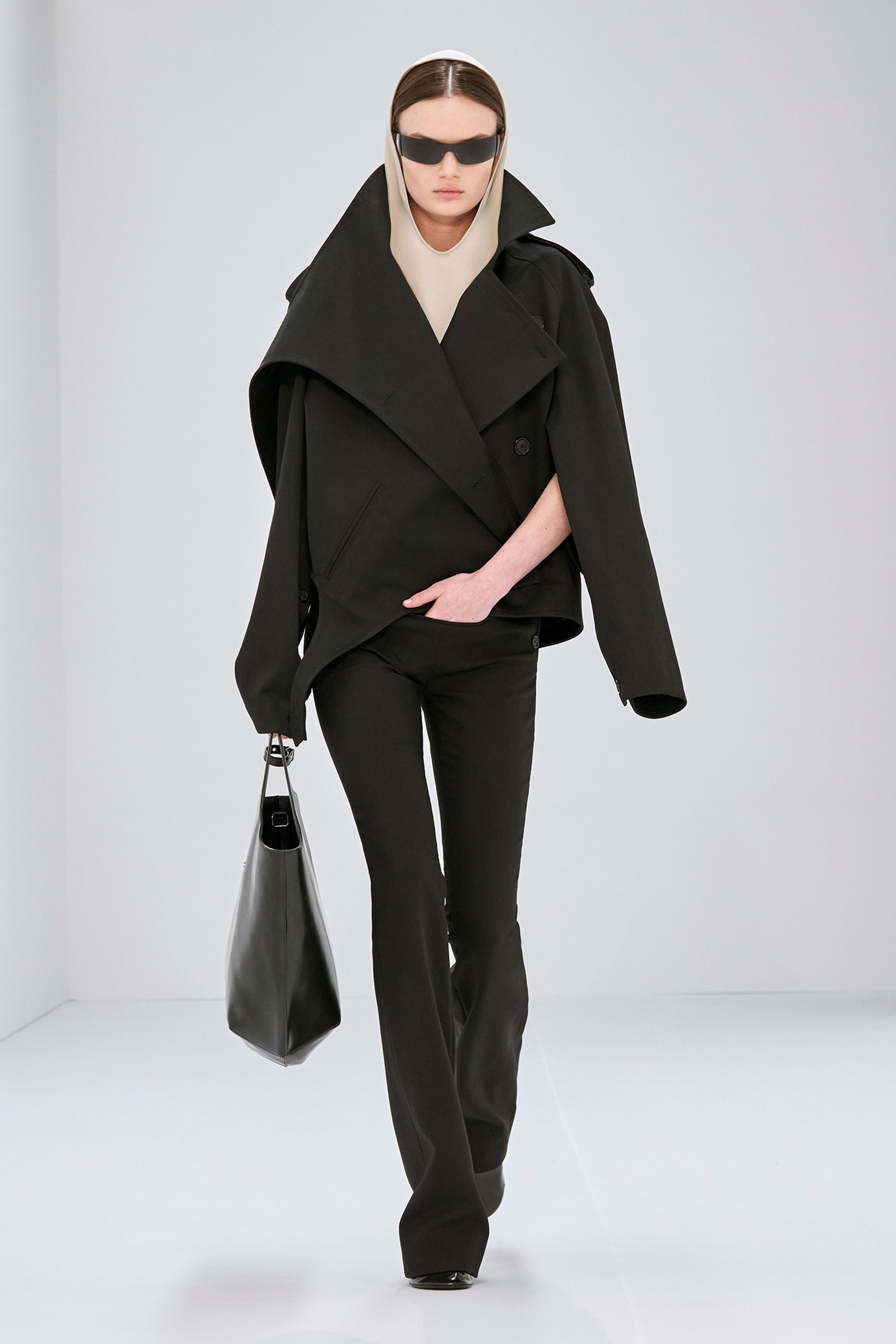 Elegant beige trench coat with high collar and shoulder epaulets, Courrèges fashion style.