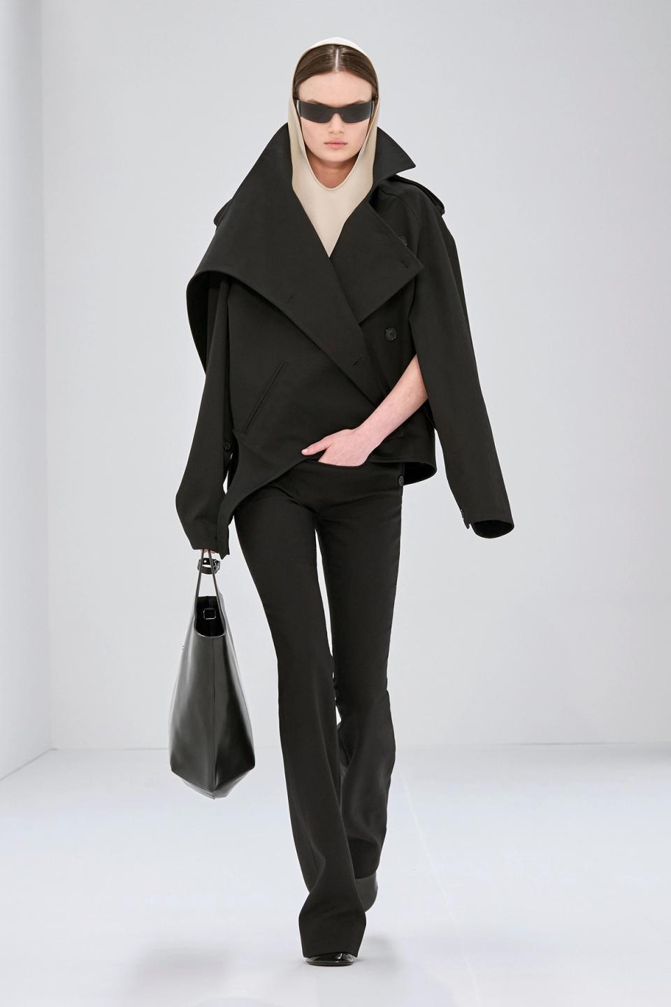 Elegant beige trench coat with high collar and shoulder epaulets, Courrèges fashion style.