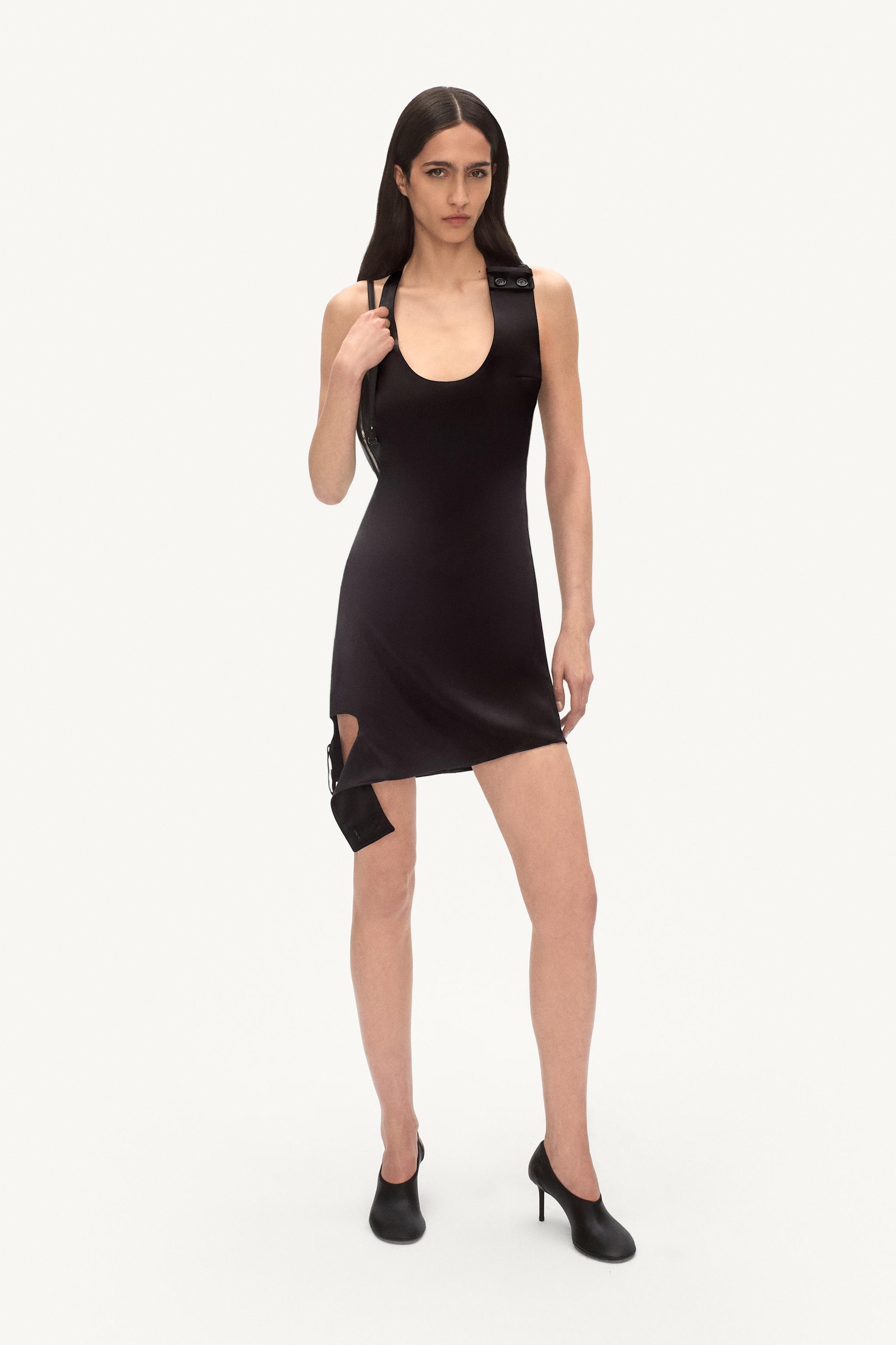 Elegant black dress by Courrèges featuring a modern design with minimalist style.