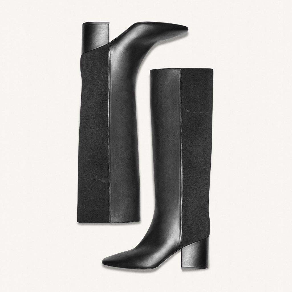 Elegant black knee-high leather boots by Courrèges, perfect for fashionable winter looks.