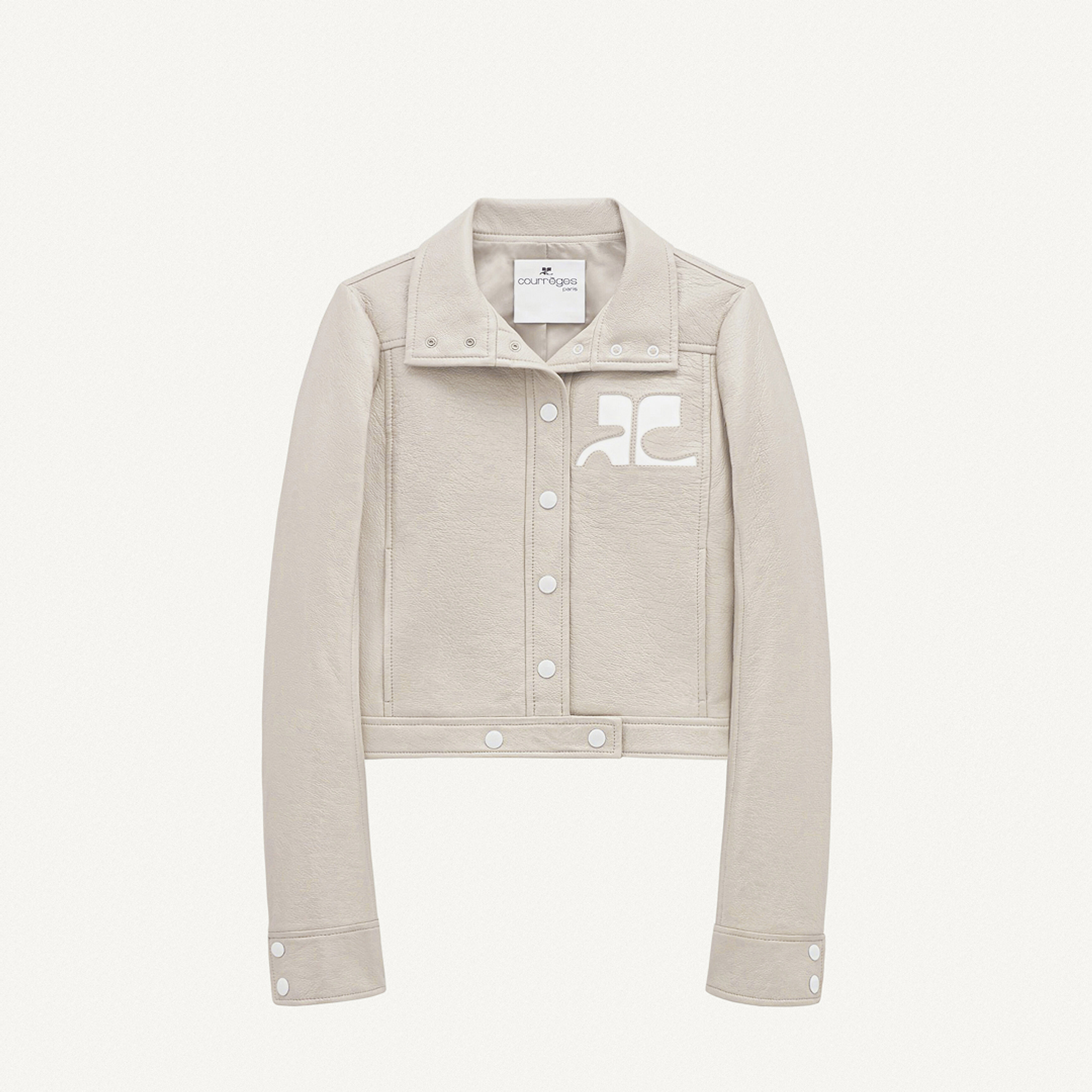 Elegant beige Courrèges denim jacket with white logo, perfect for a fashion-forward look.