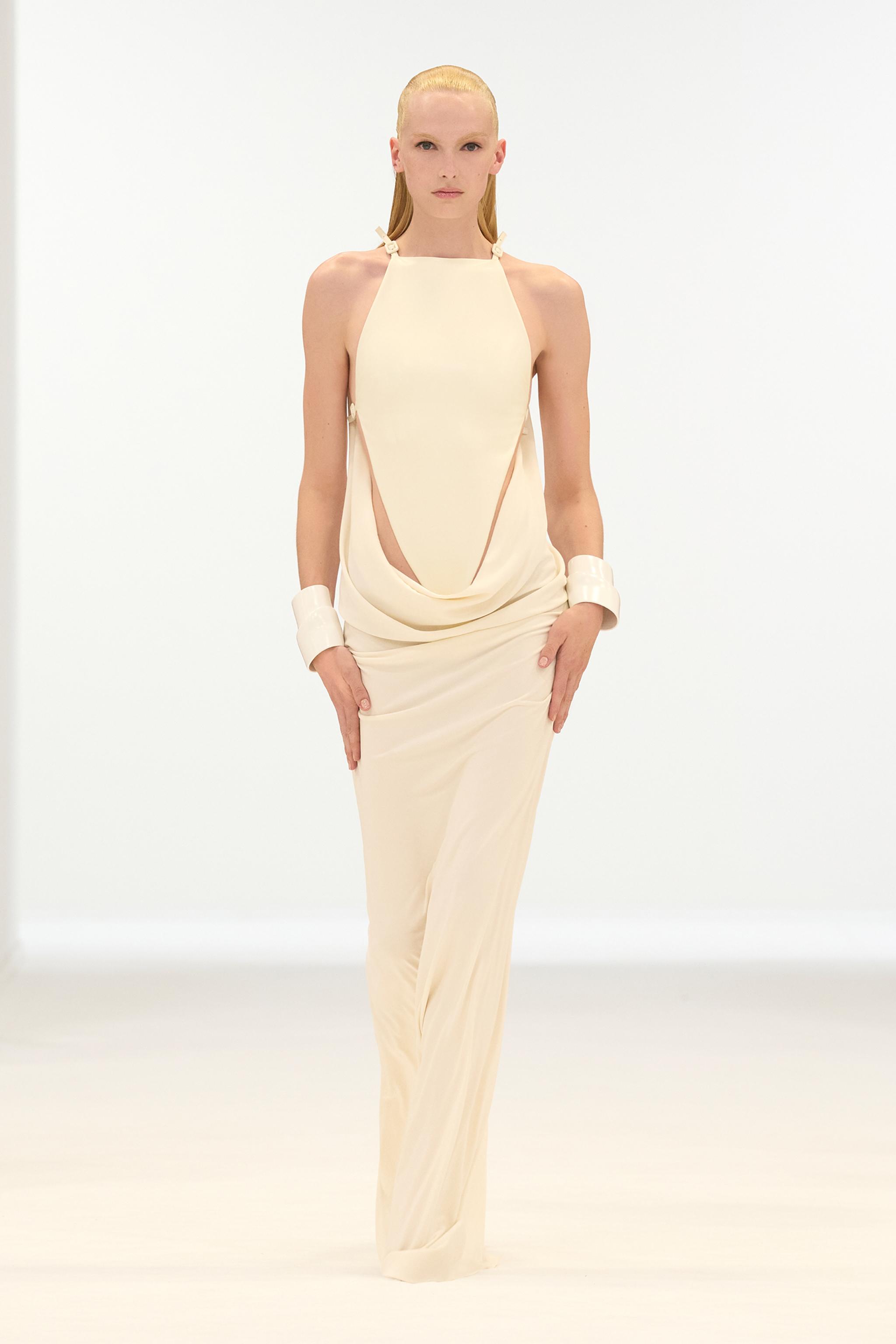 Elegant beige dress by Courrèges, featuring modern cutouts, perfect for fashion-forward ecommerce displays.