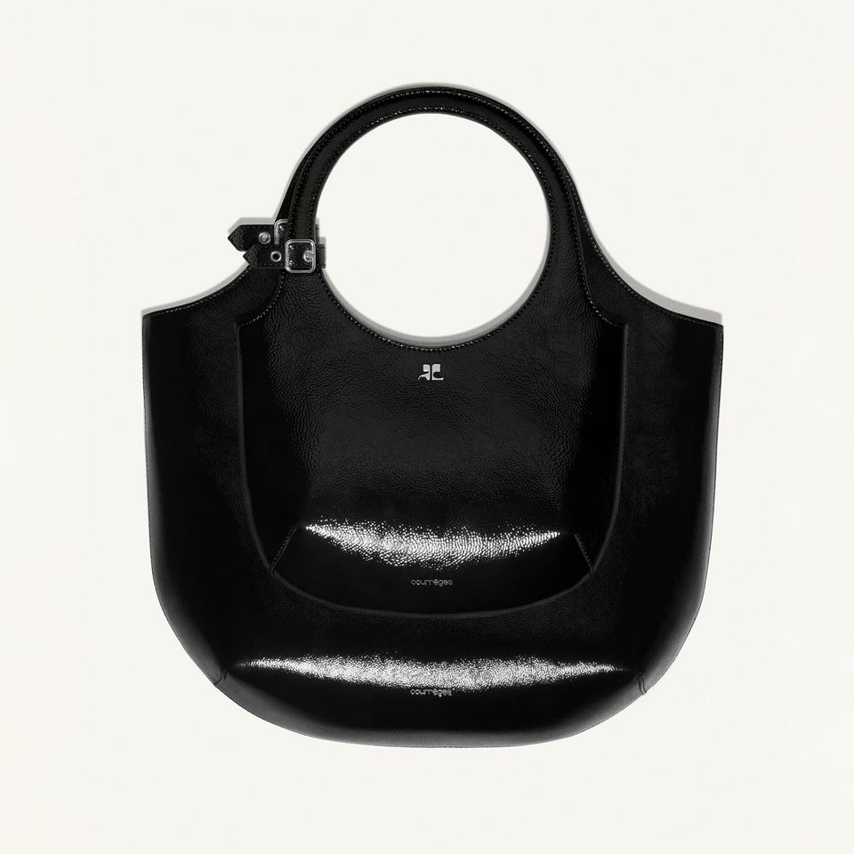 Elegant black Courrèges handbag with circular handle, glossy finish, perfect for fashion accessories.