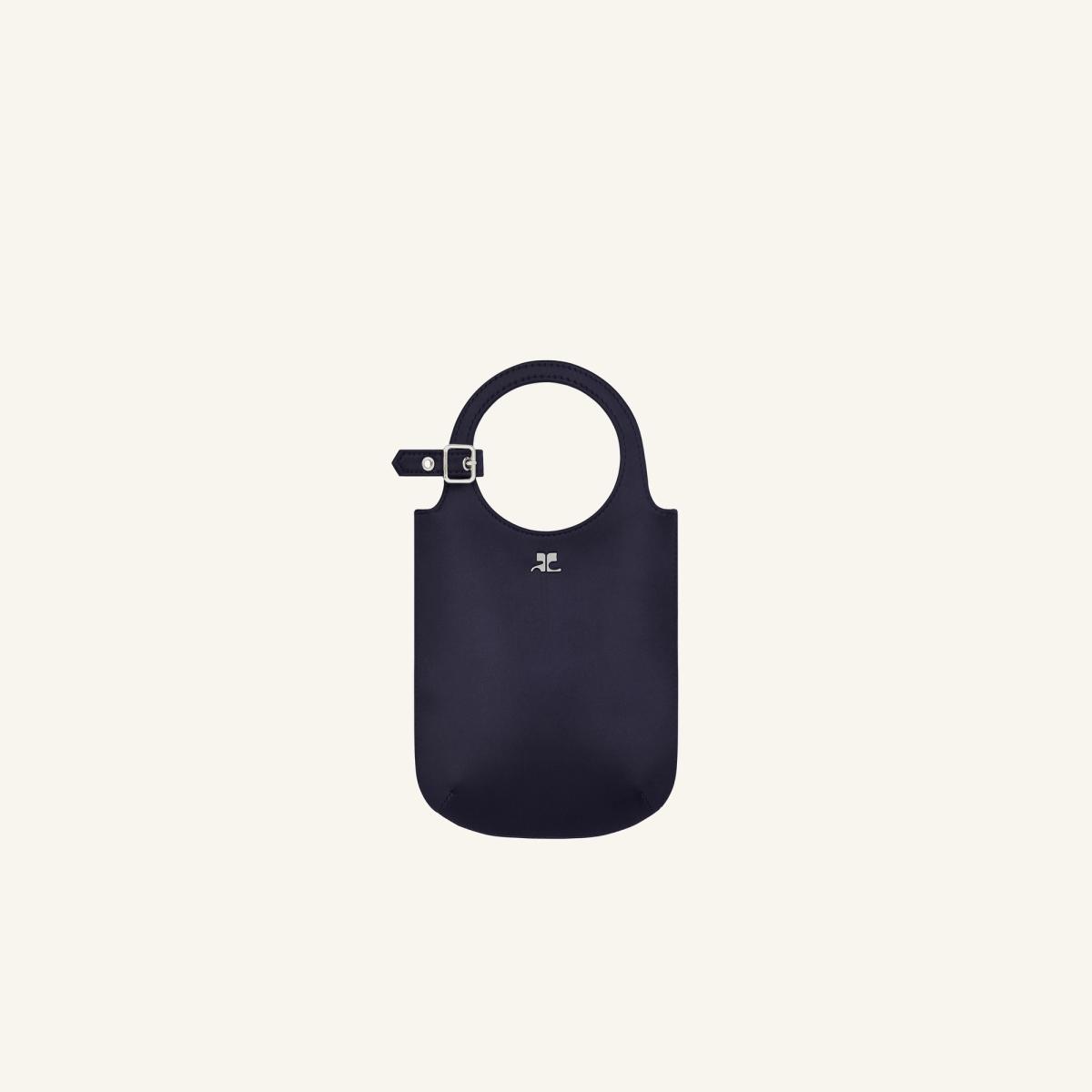 Elegant navy handbag with circular handle and minimalist design from Courrèges for fashion lovers.