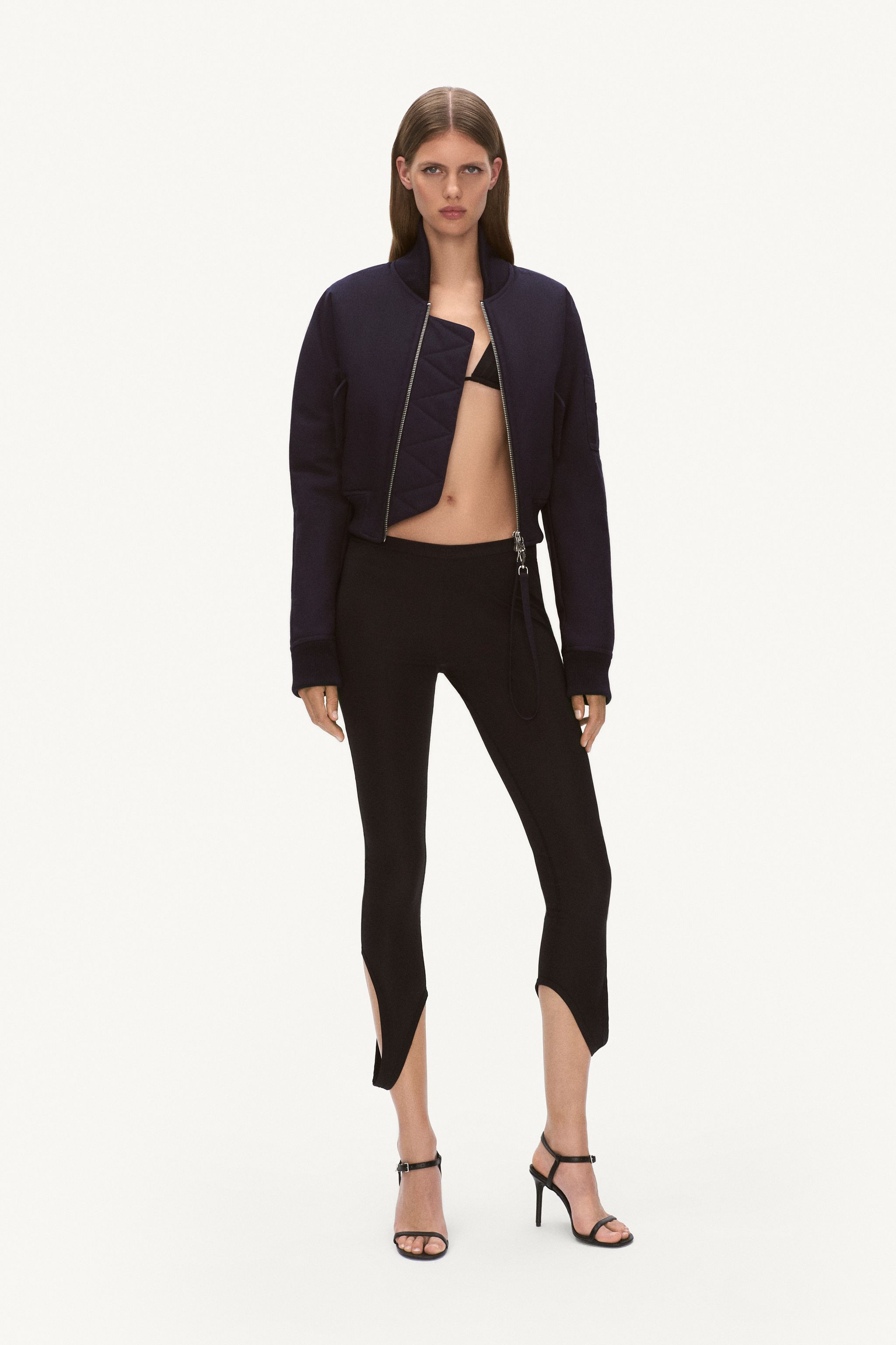Elegant black and navy fashion ensemble featuring a cropped jacket, fitted pants, and high heels for Courrèges.