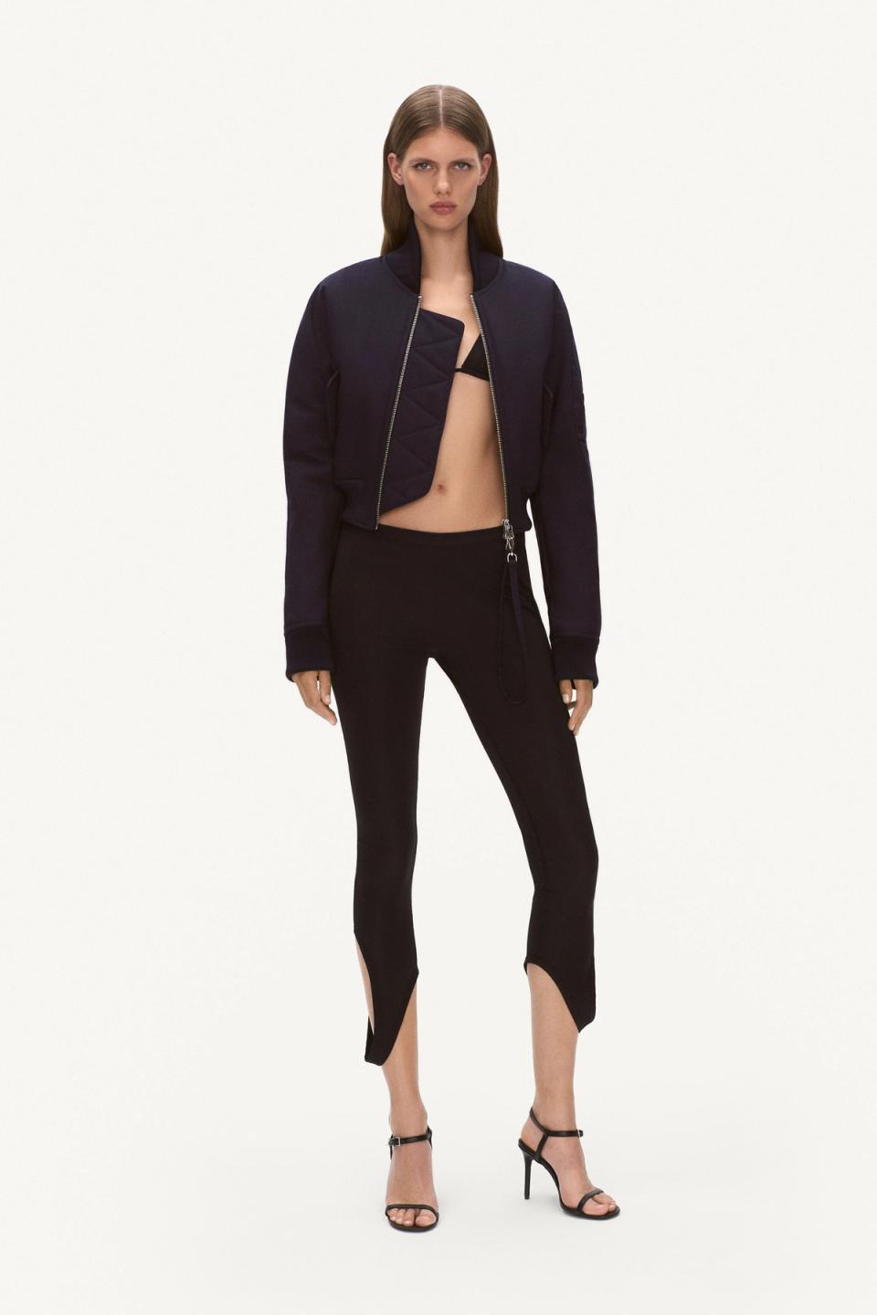 Elegant black and navy fashion ensemble featuring a cropped jacket, fitted pants, and high heels for Courrèges.