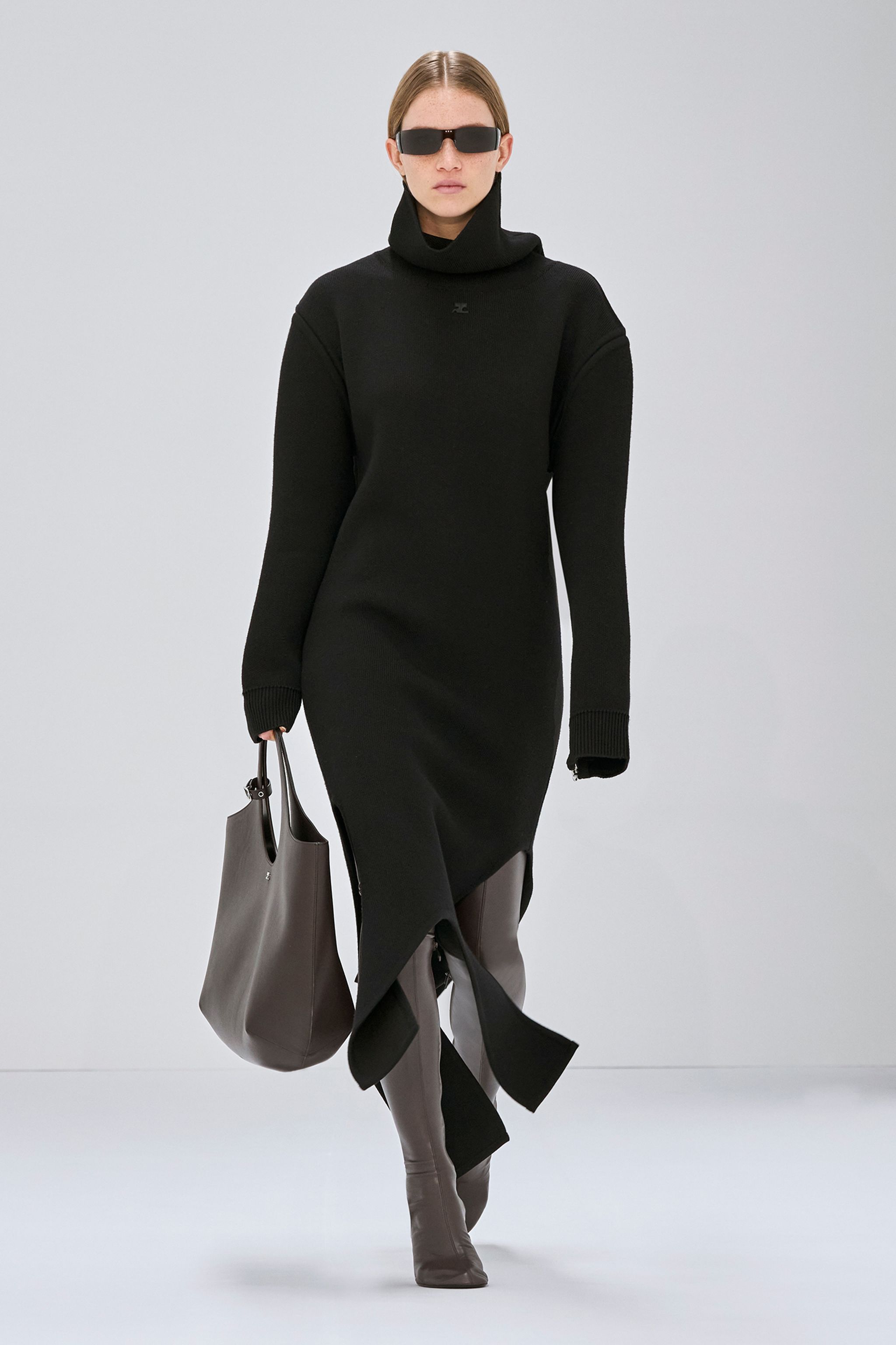 Elegant black turtleneck dress with asymmetric hem, perfect for Courrèges fashion collection.