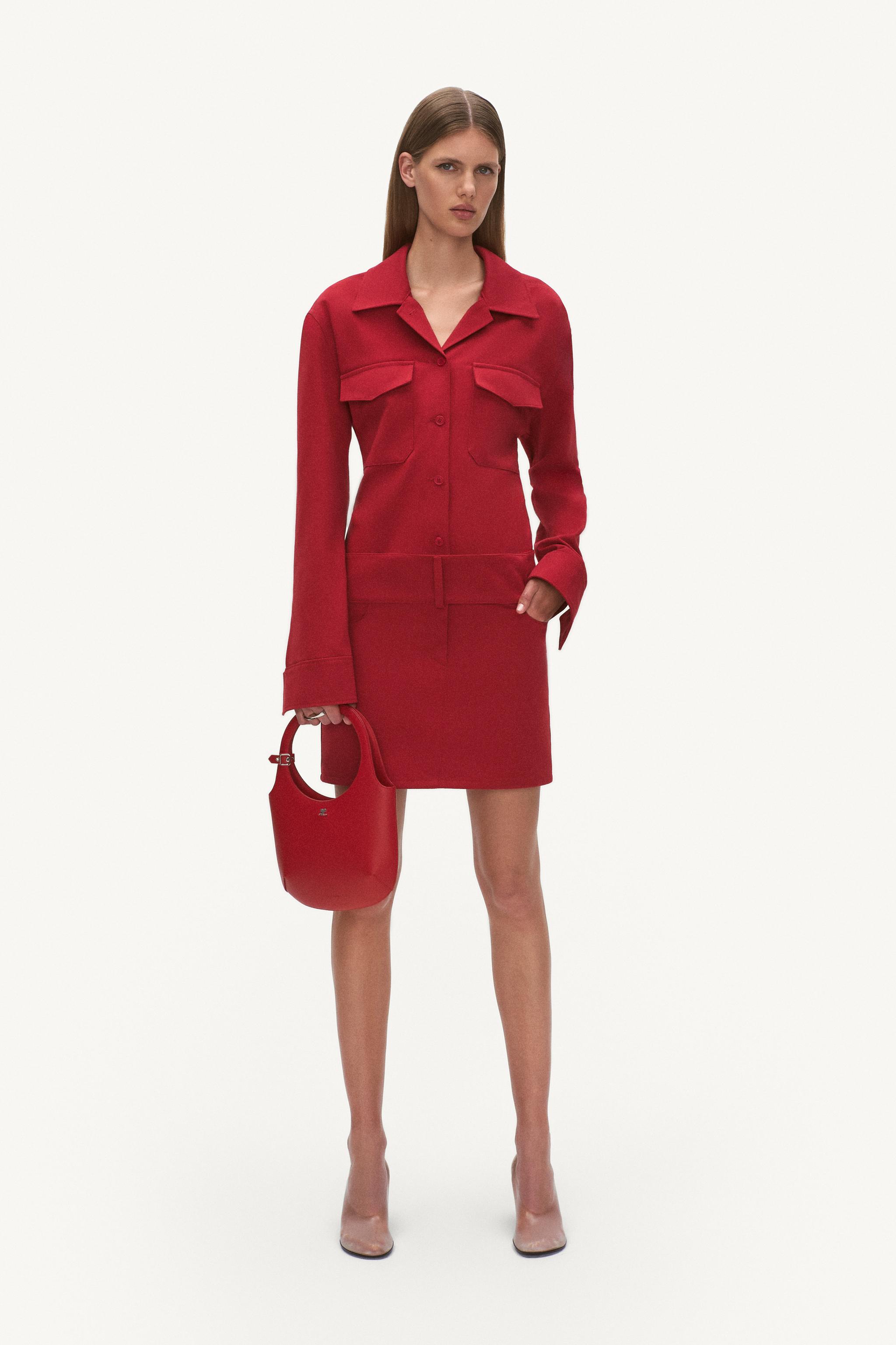 Elegant red Courrèges outfit featuring a tailored jacket, matching skirt, and stylish handbag.