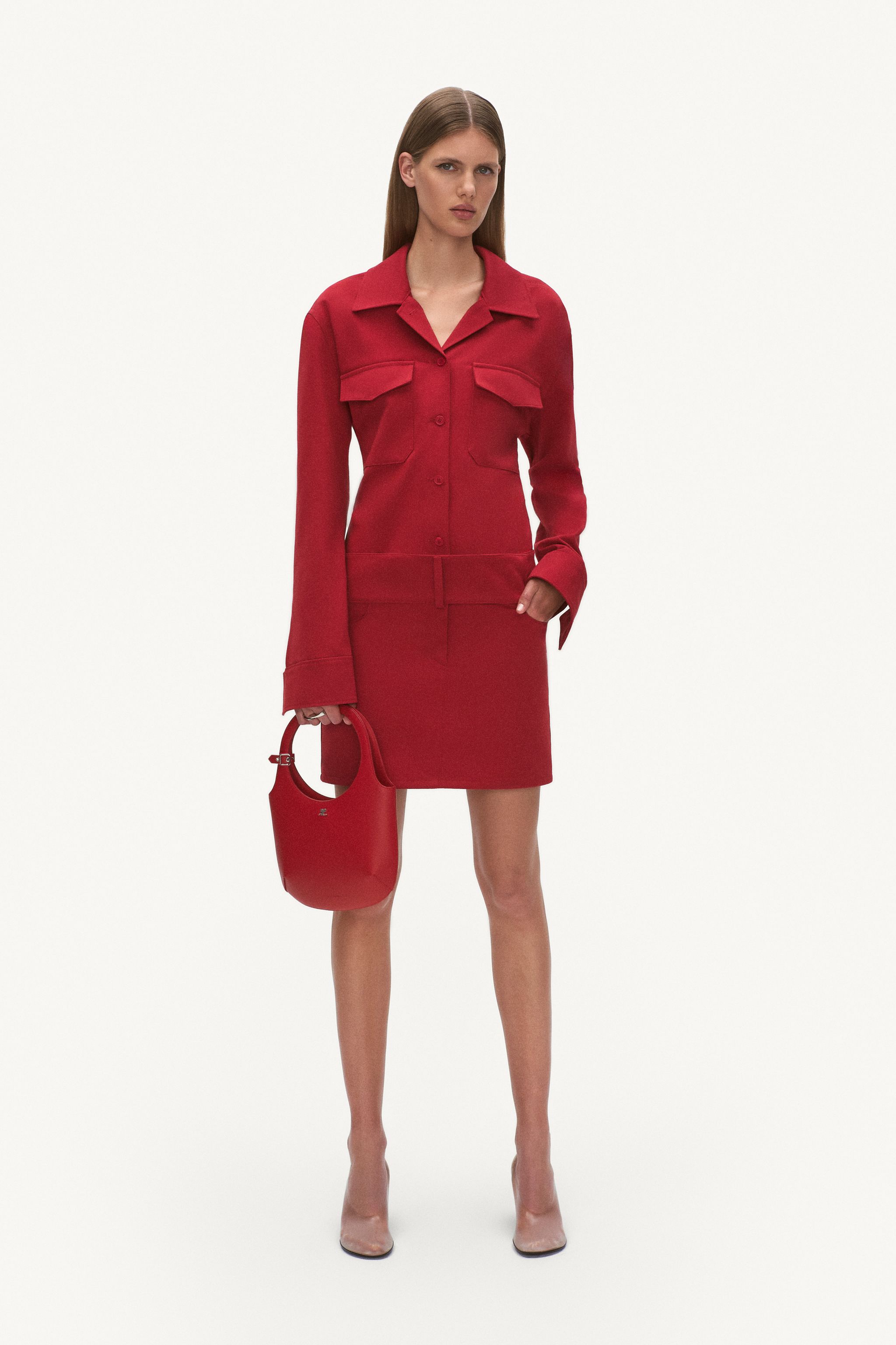 Elegant red Courrèges outfit featuring a button-up jacket, matching skirt, and a stylish handbag.