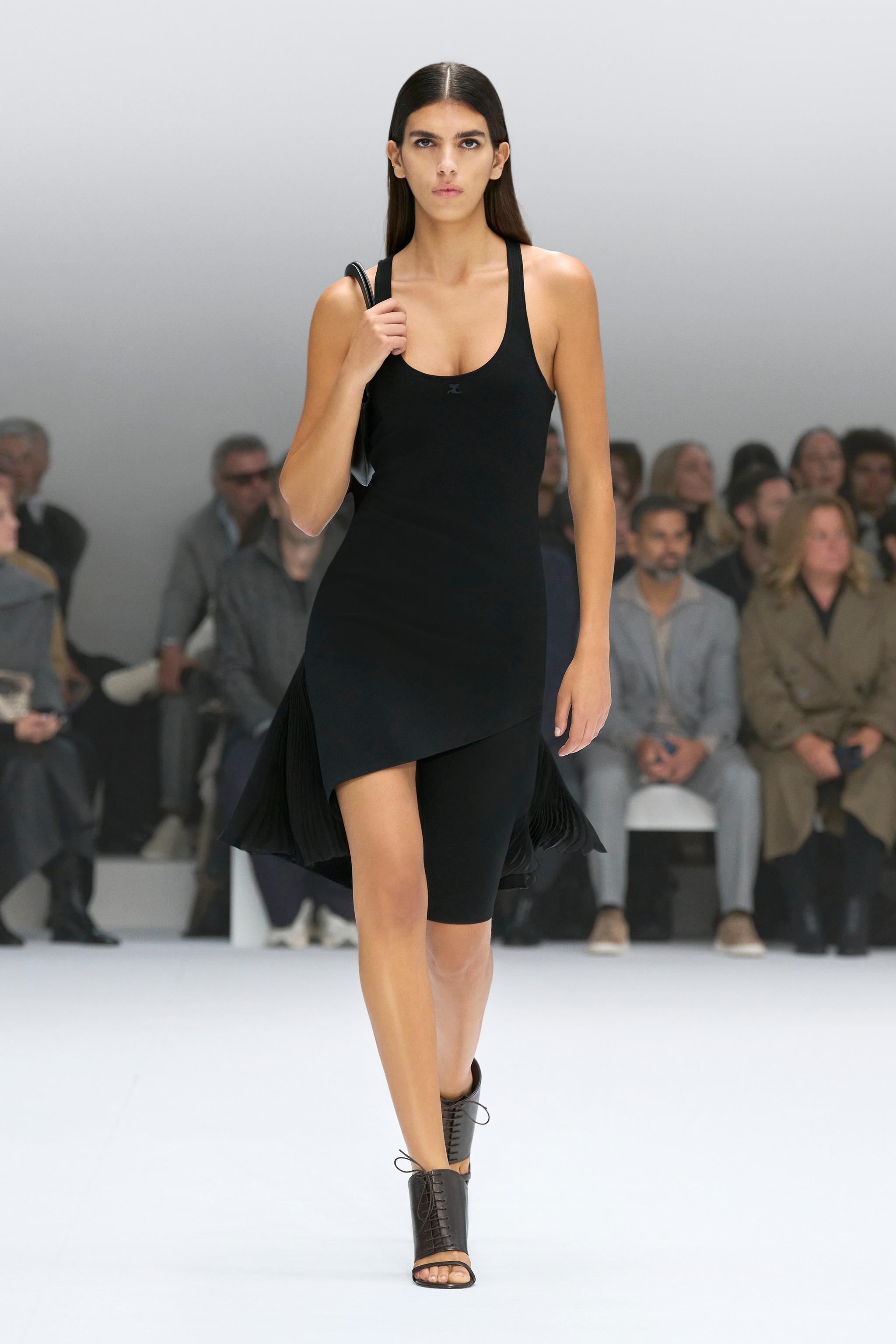 Elegant black dress by Courrèges showcased on a runway, perfect for modern fashionistas.