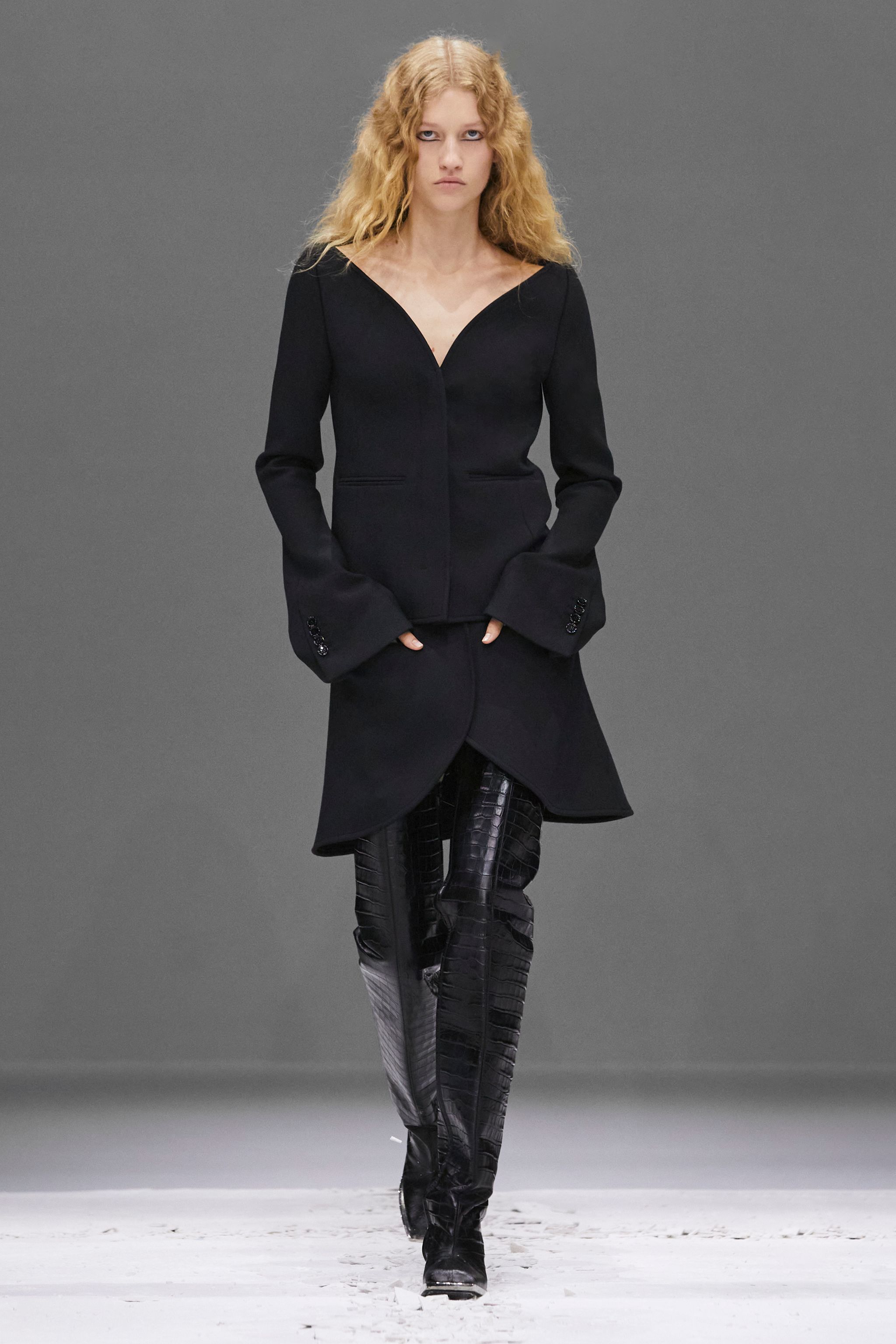 Elegant black oversized hoodie with a deep neckline, styled for Courrèges' modern fashion look.