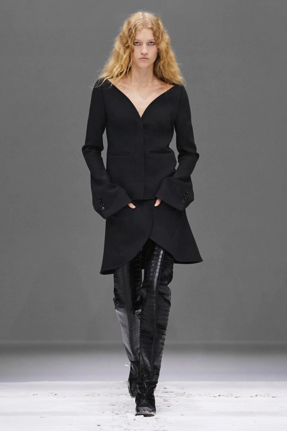Elegant black oversized hoodie with a deep neckline, styled for Courrèges' modern fashion look.