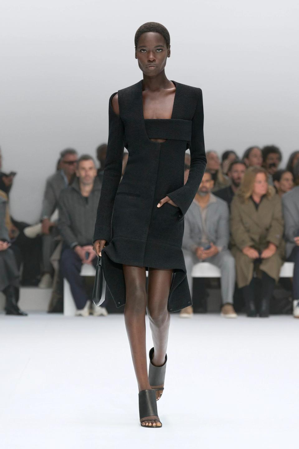 Elegant black dress with cutouts, styled for the Courrèges fashion brand runway show.