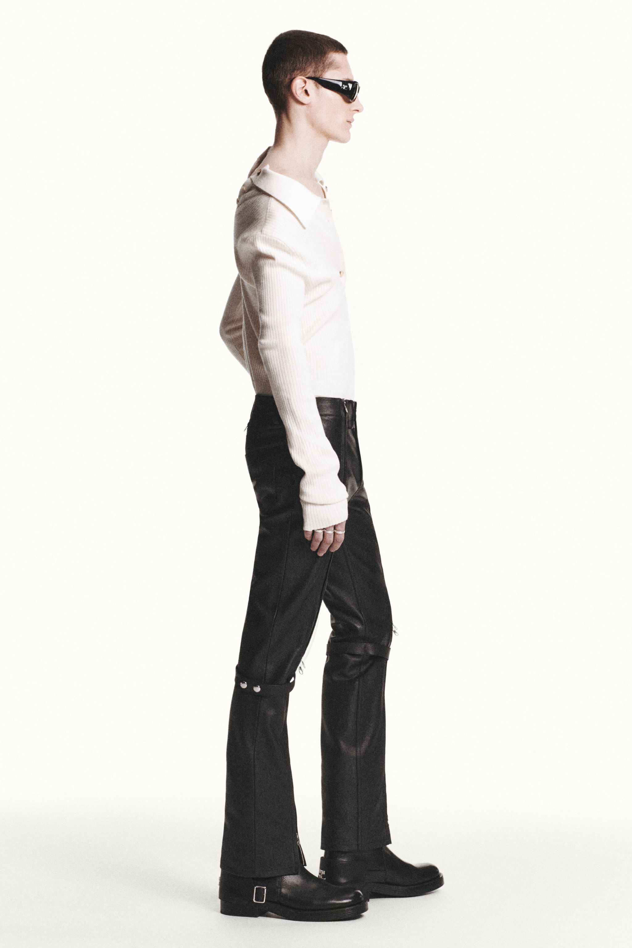 Elegant, modern fashion look with black leather pants and stylish sunglasses for Courrèges.