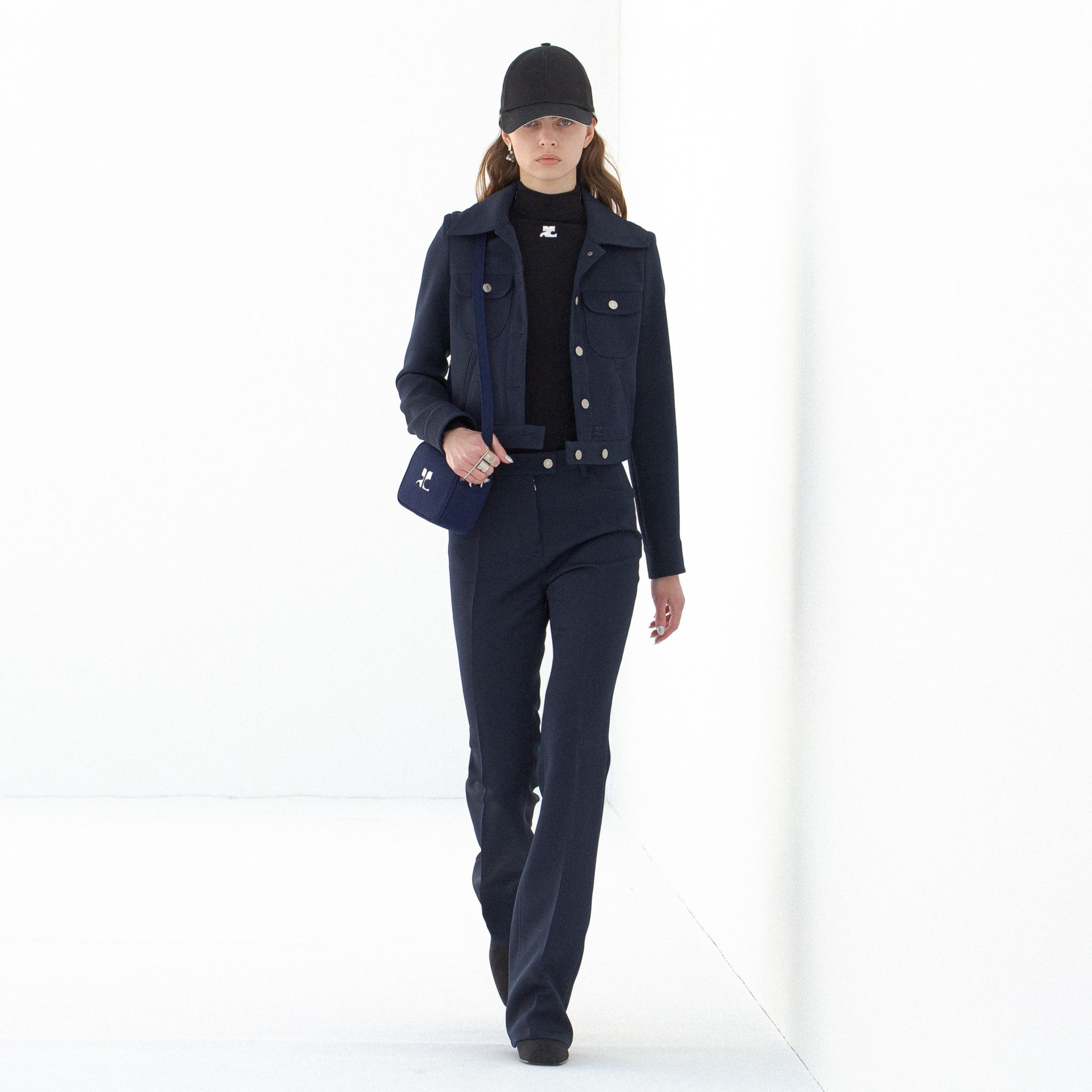 Elegant navy tracksuit with matching accessories, Courrèges fashion for modern style.