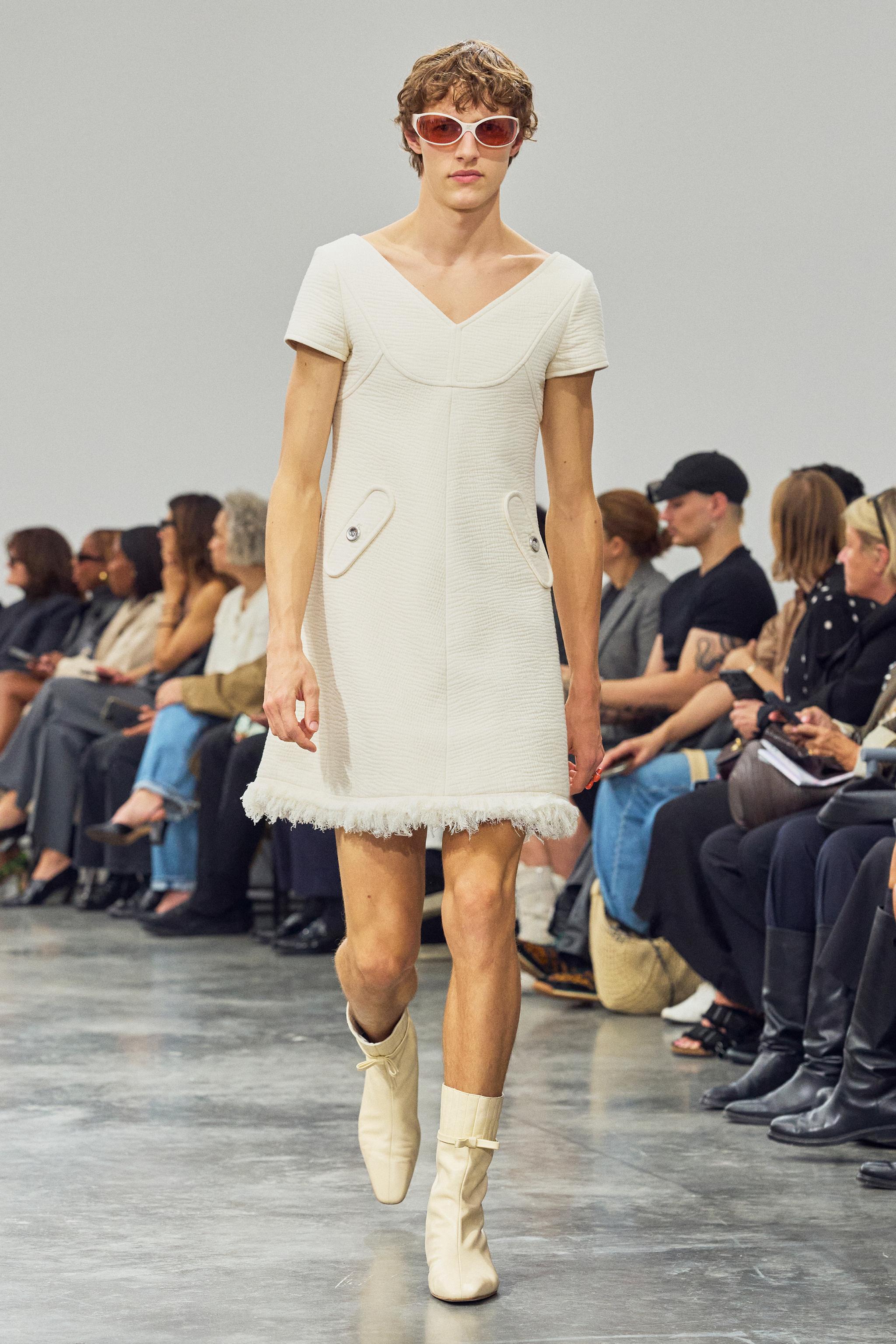 Elegant white fashion dress with textured fabric, designed for Courrèges' chic runway collection.