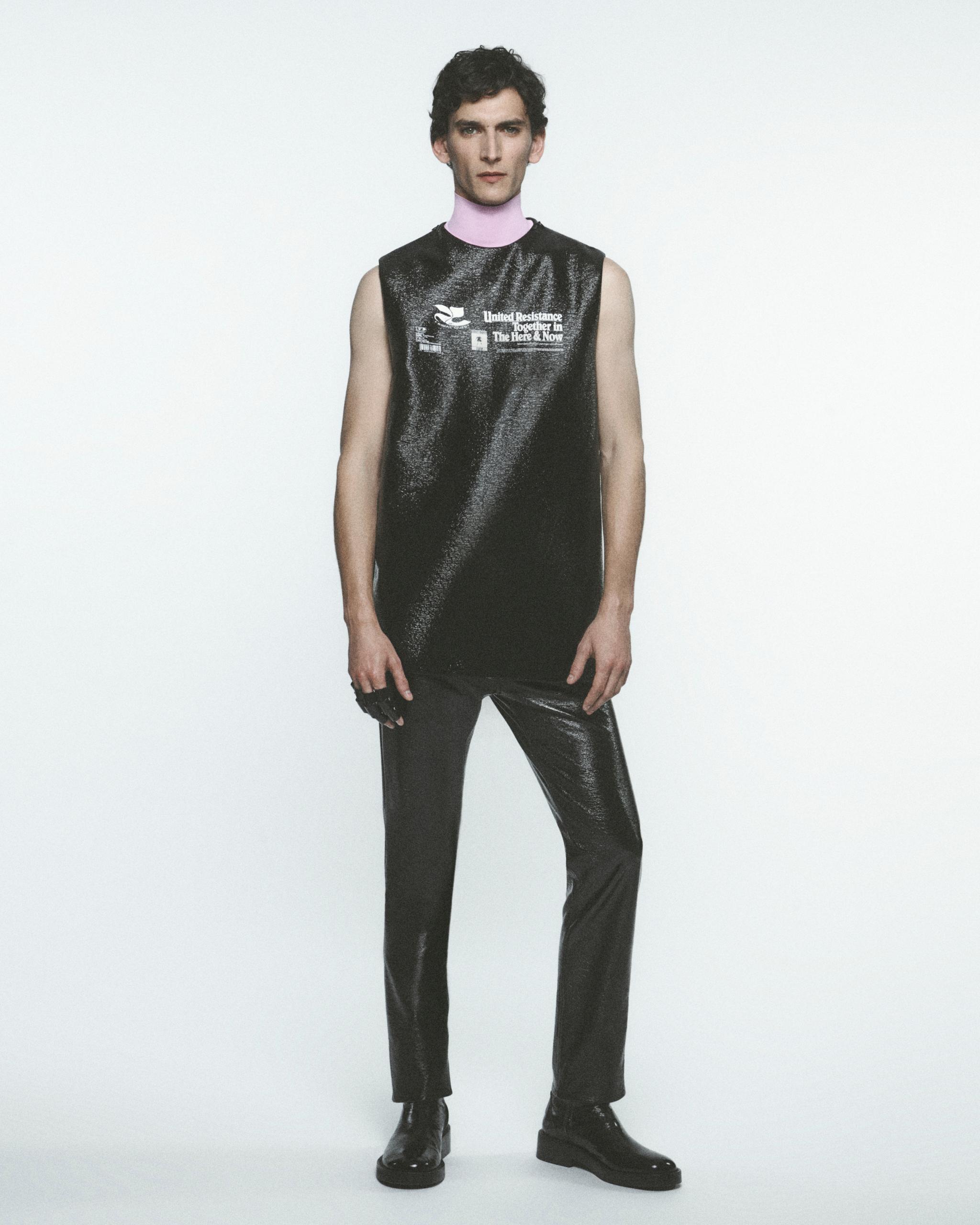 Male model in stylish black futuristic outfit for Courrèges fashion brand online shopping.