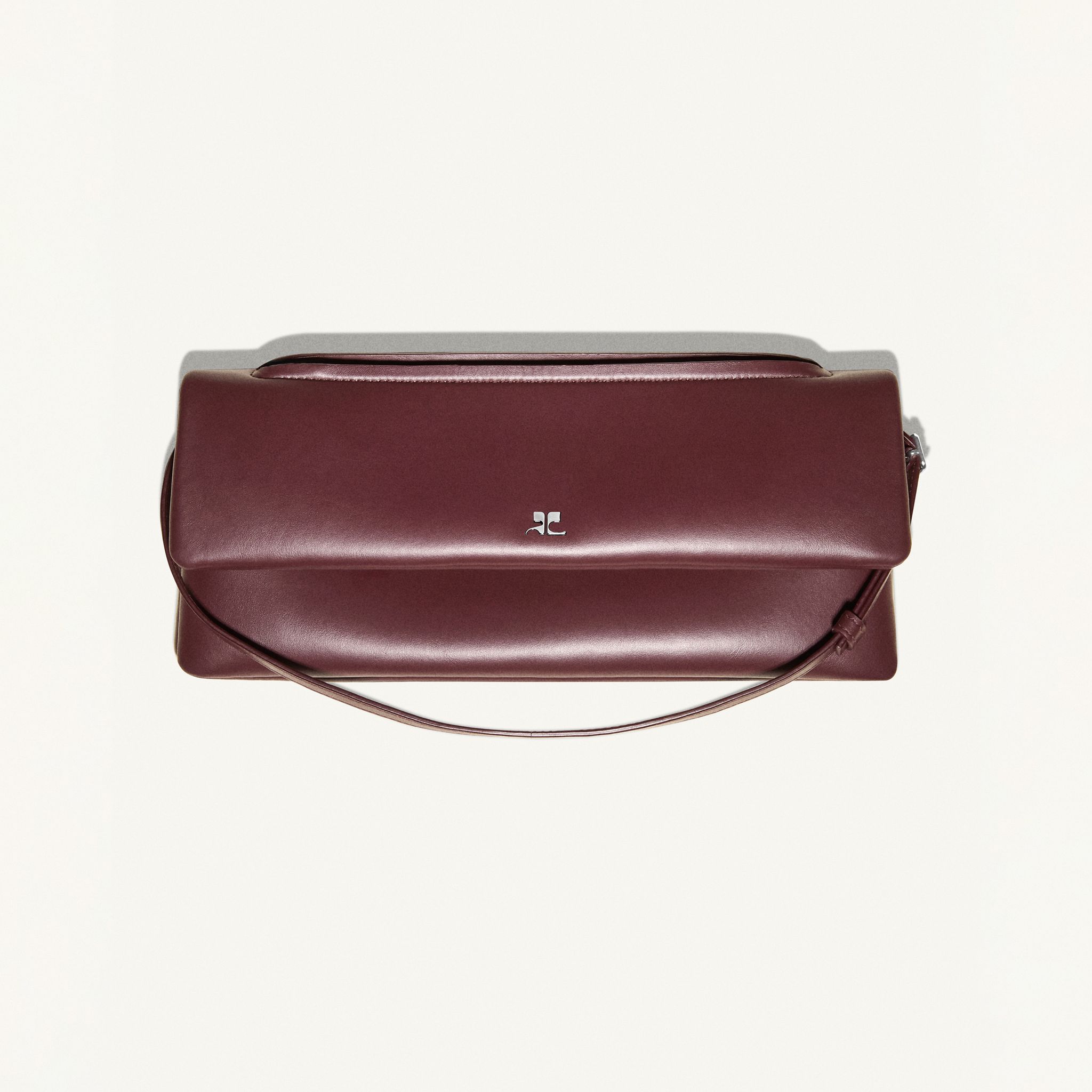 Elegant burgundy leather handbag by Courrèges, perfect for chic accessory styles.