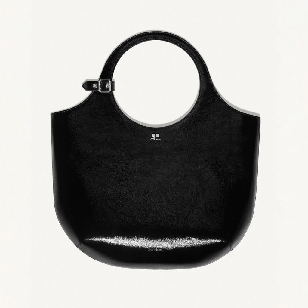 Elegant black leather handbag with a circular handle, showcasing Courrèges' modern fashion style.