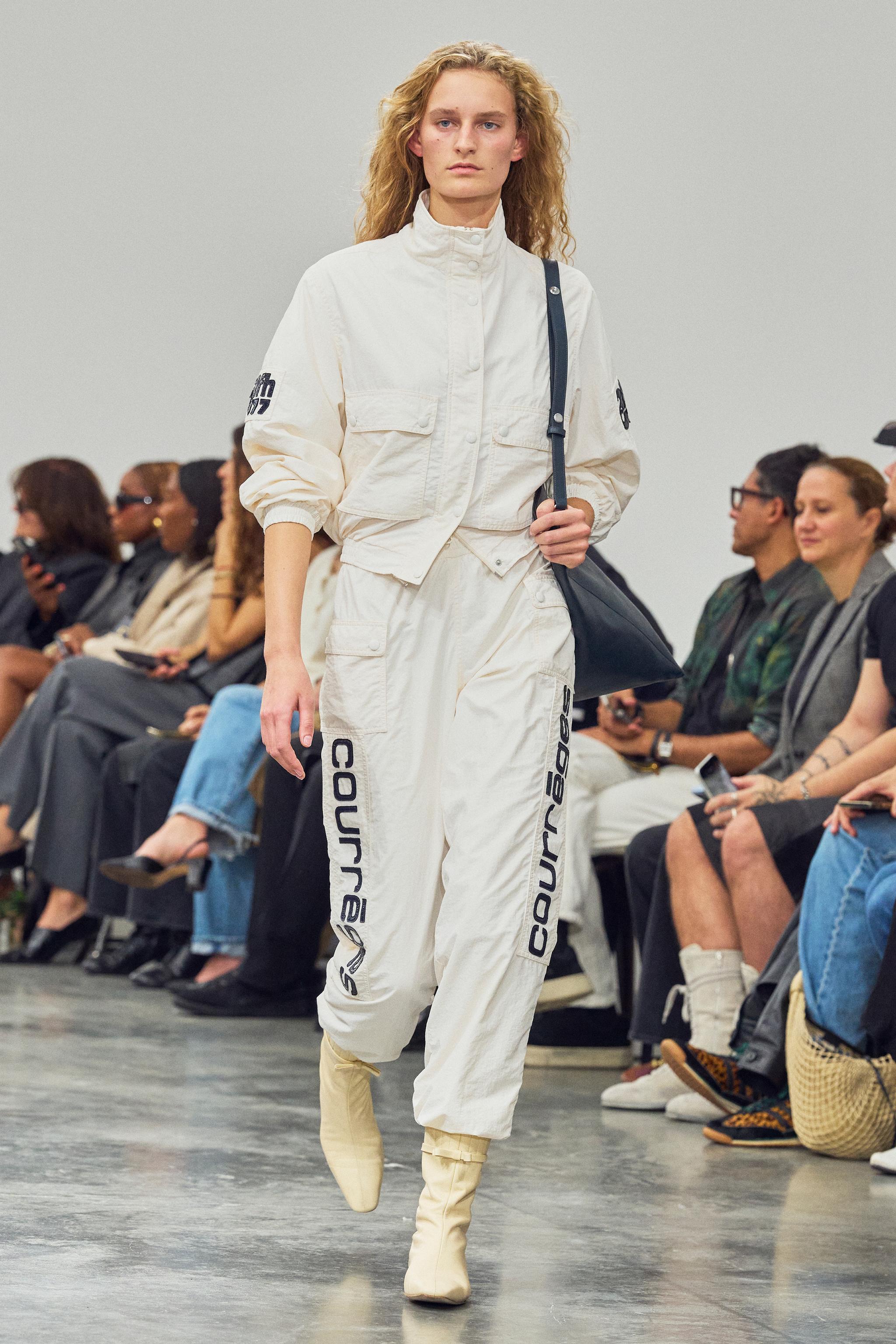 Elegant Courrèges fashion model showcasing contemporary streetwear at a runway event.