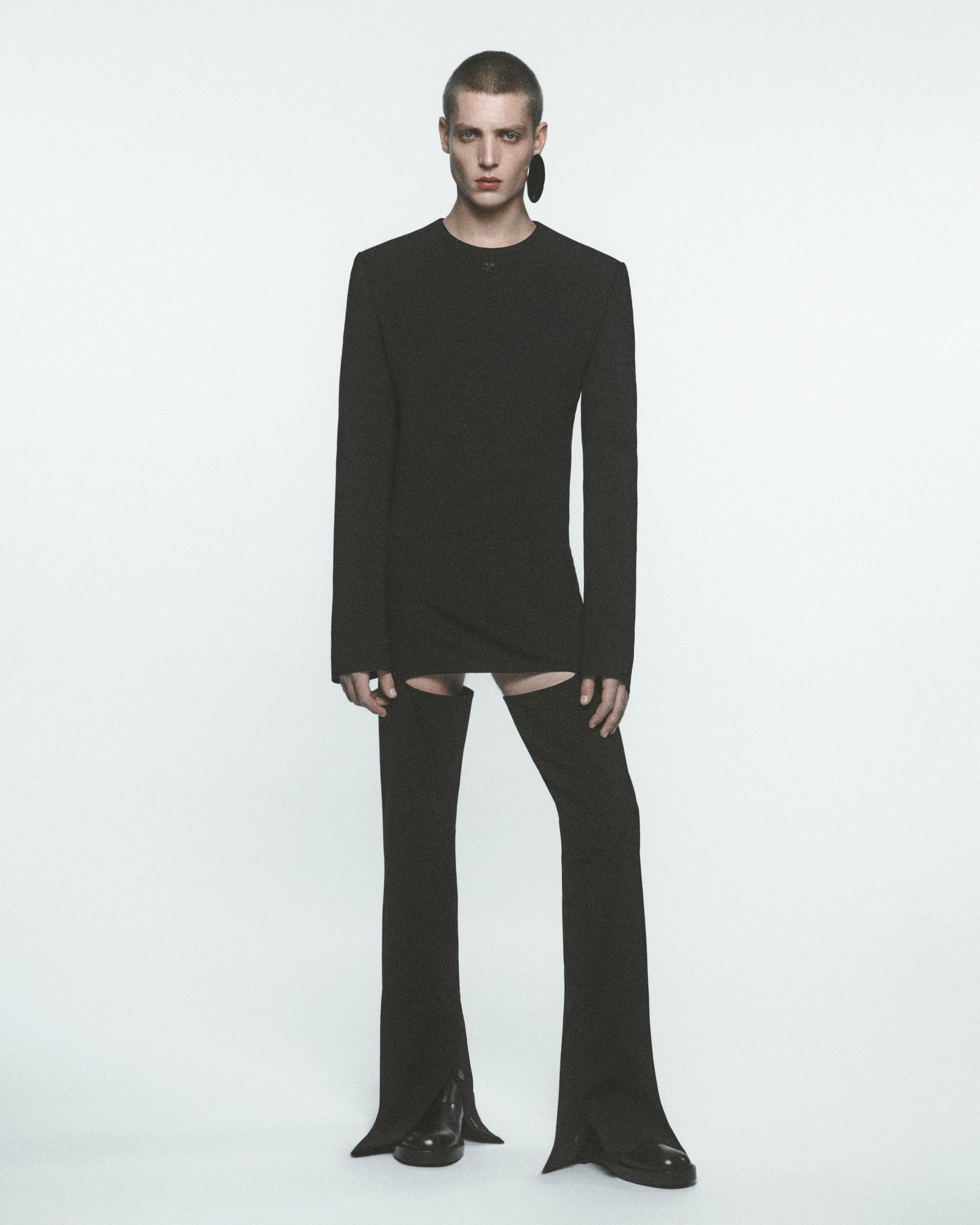 Elegant model in black Courrèges attire showcasing modern Parisian fashion style.
