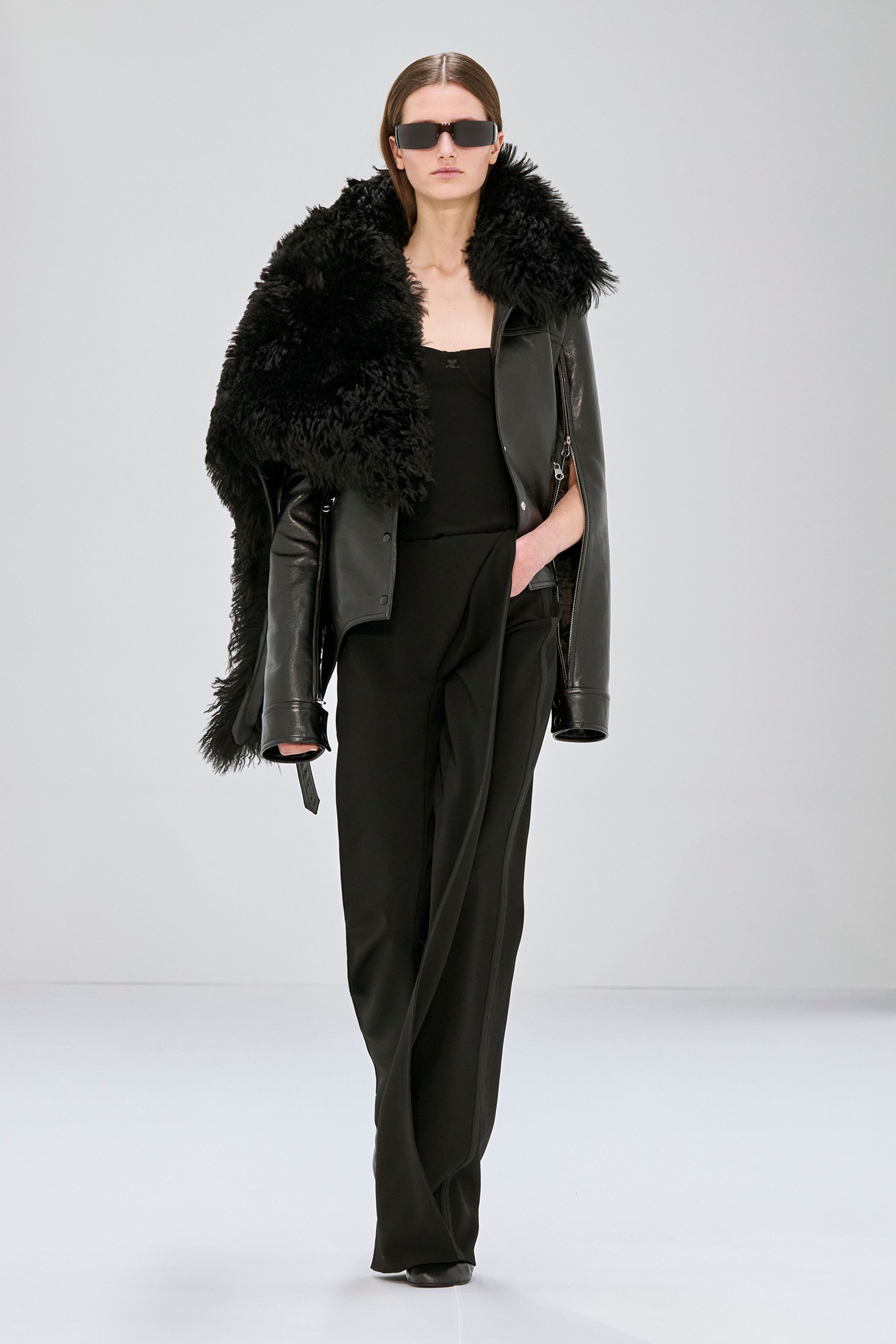 Elegant black leather jacket with fuzzy collar, runway-ready fashion from Courrèges.