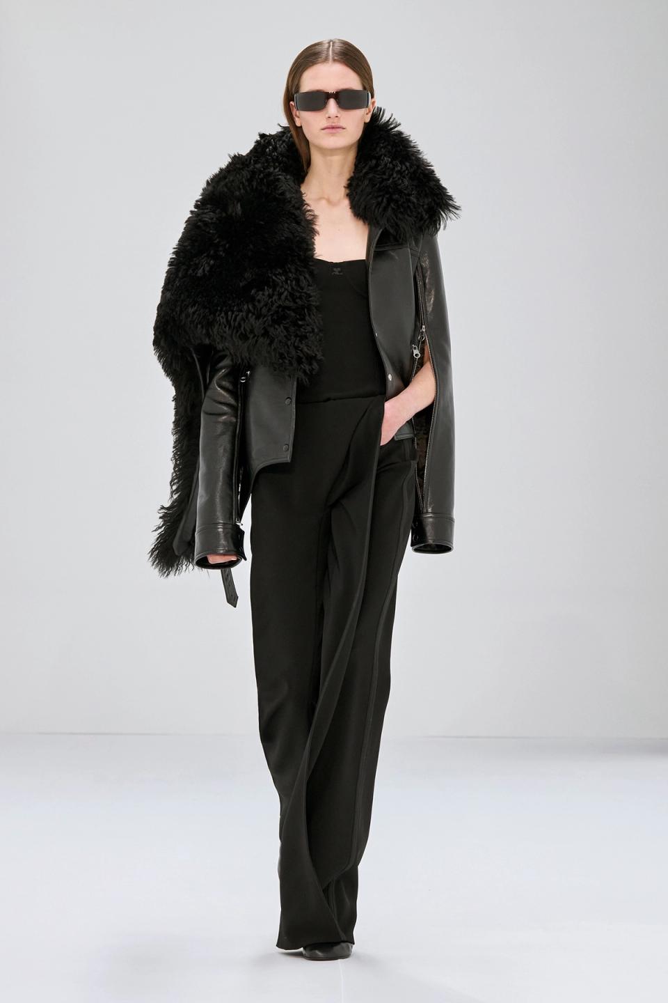 Elegant black leather jacket with fuzzy collar, runway-ready fashion from Courrèges.