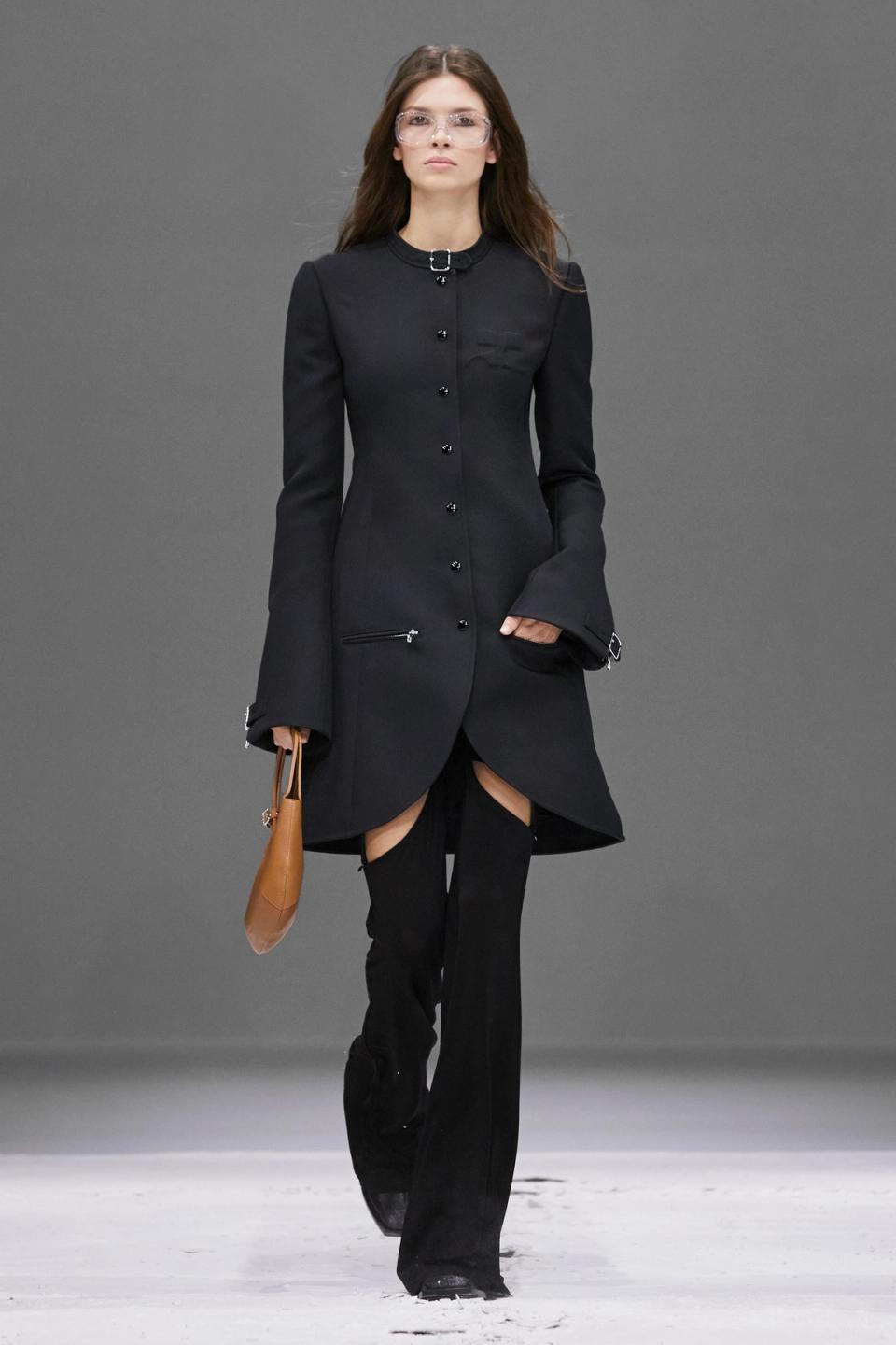 Elegant black Courrèges coat with tailored fit, stylish details, perfect for fashion-forward wear.