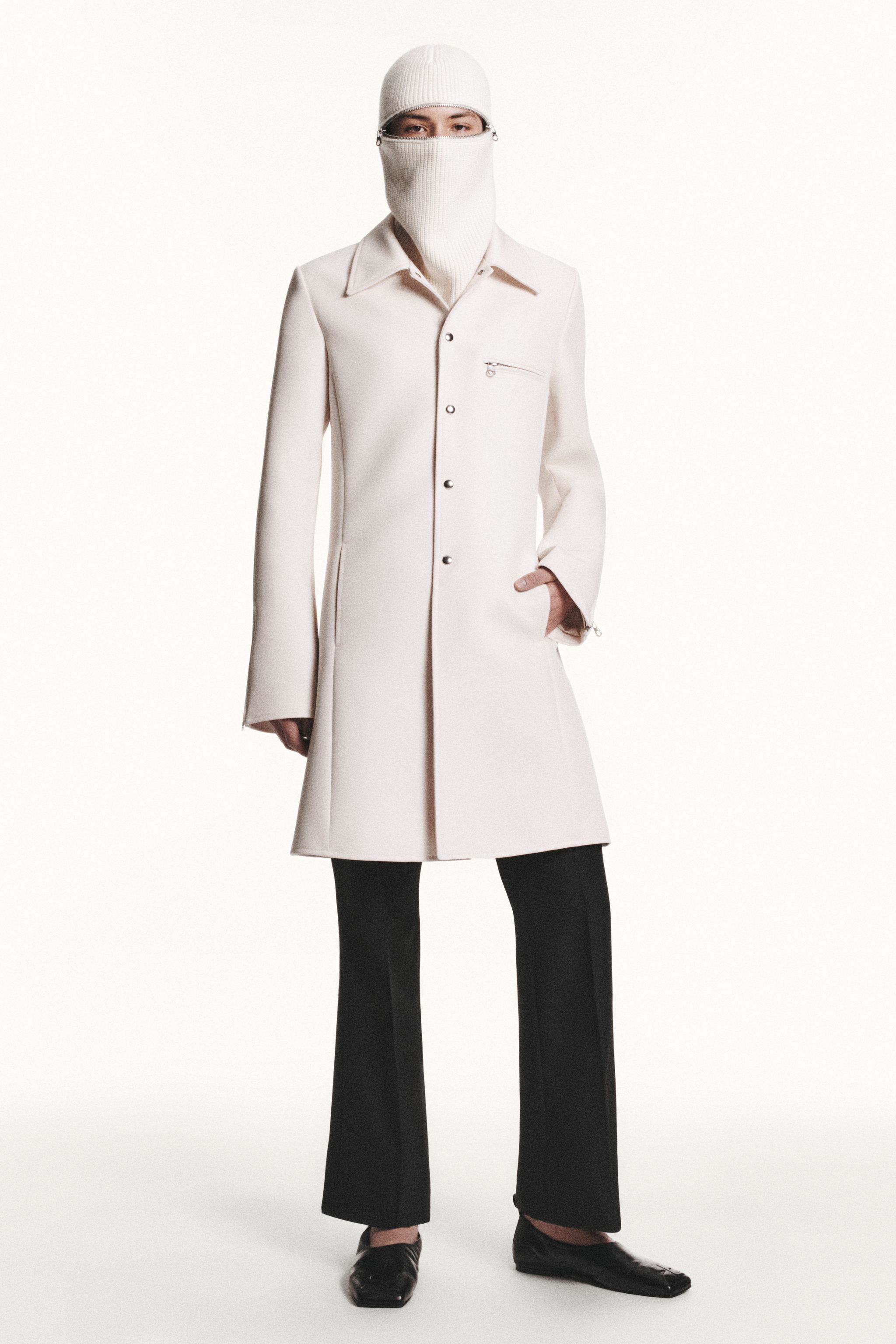 Elegant white coat with a stylish zip detail, part of Courrèges' modern fashion collection.