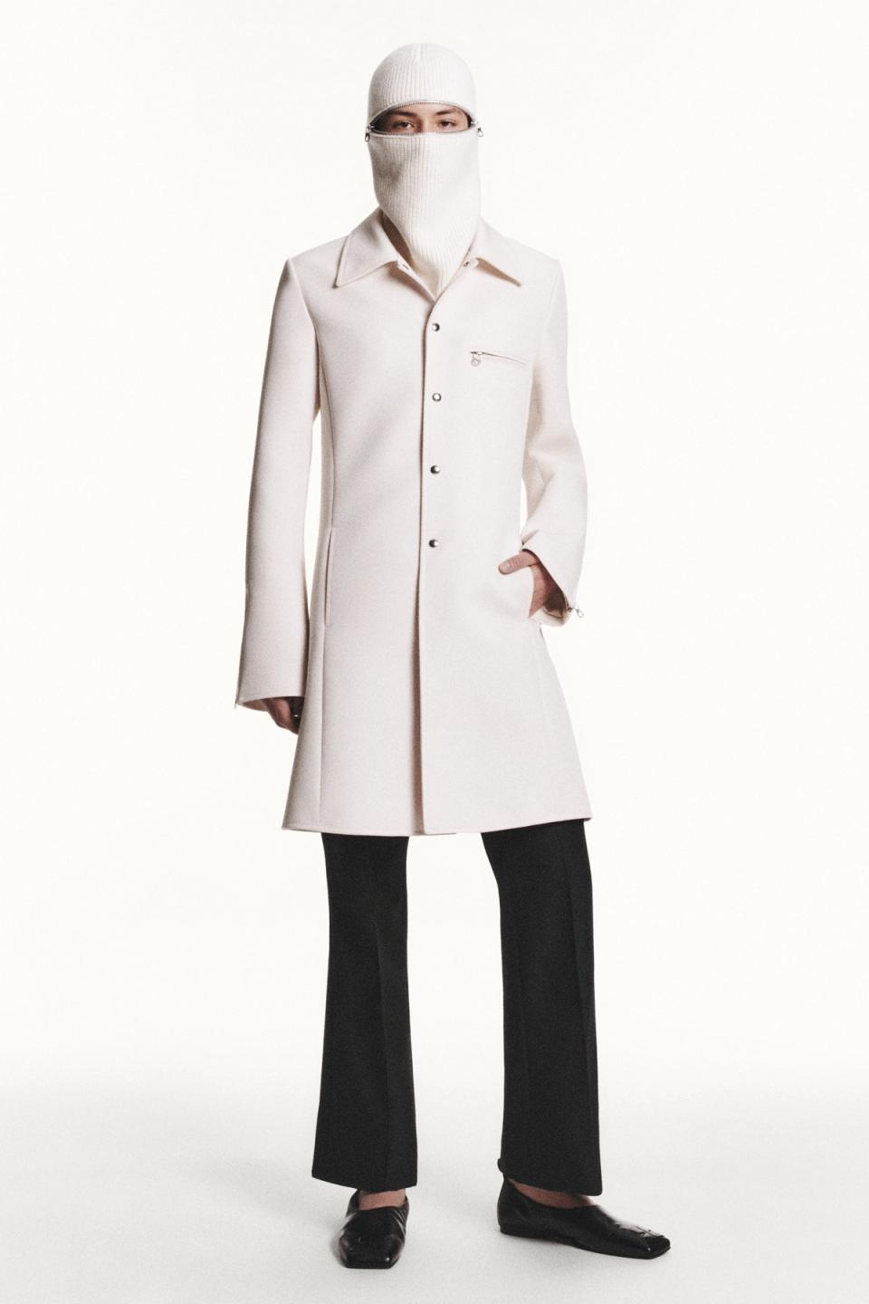 Elegant white coat with a stylish zip detail, part of Courrèges' modern fashion collection.