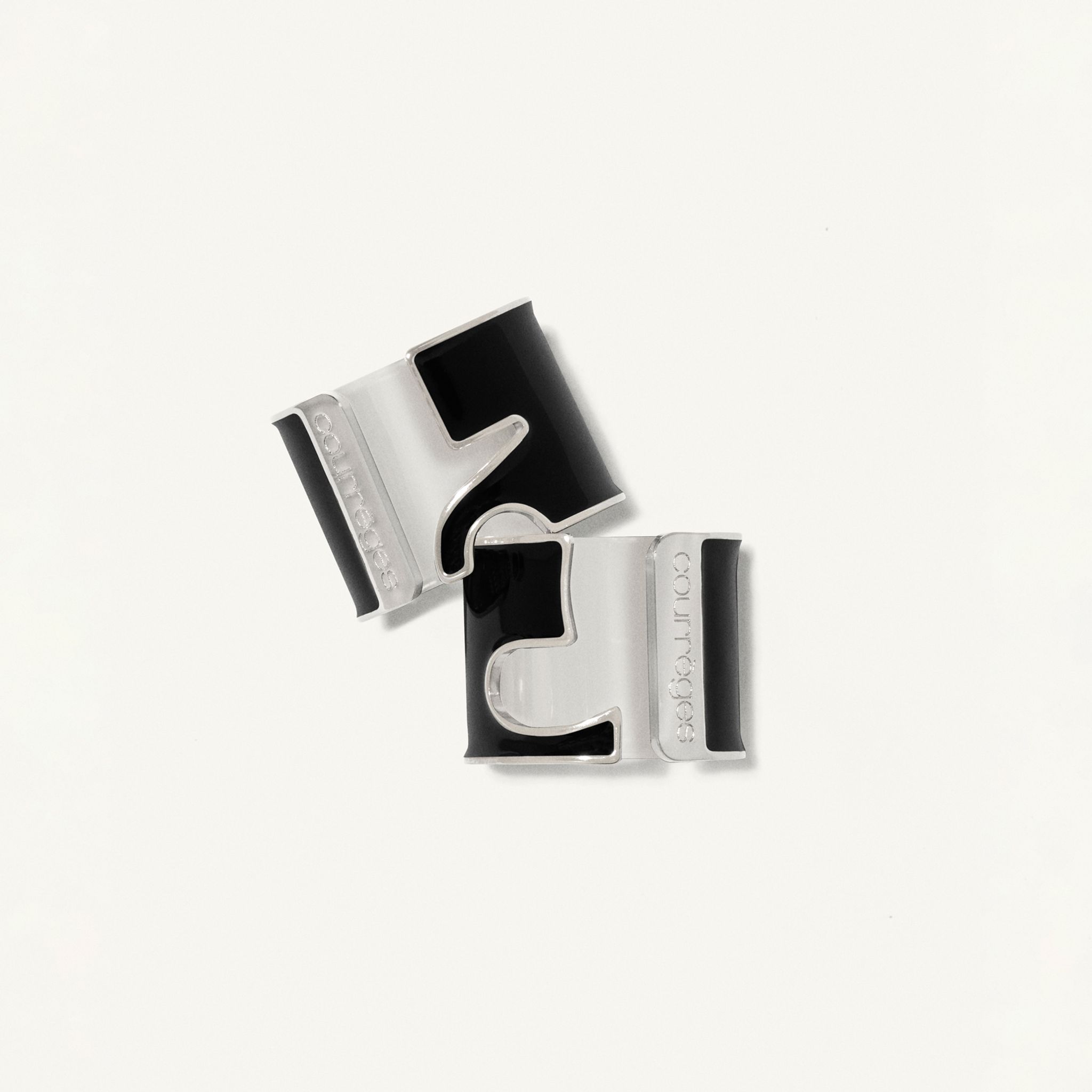 Elegant black and silver cufflinks featuring Courrèges branding, perfect for sophisticated fashion.