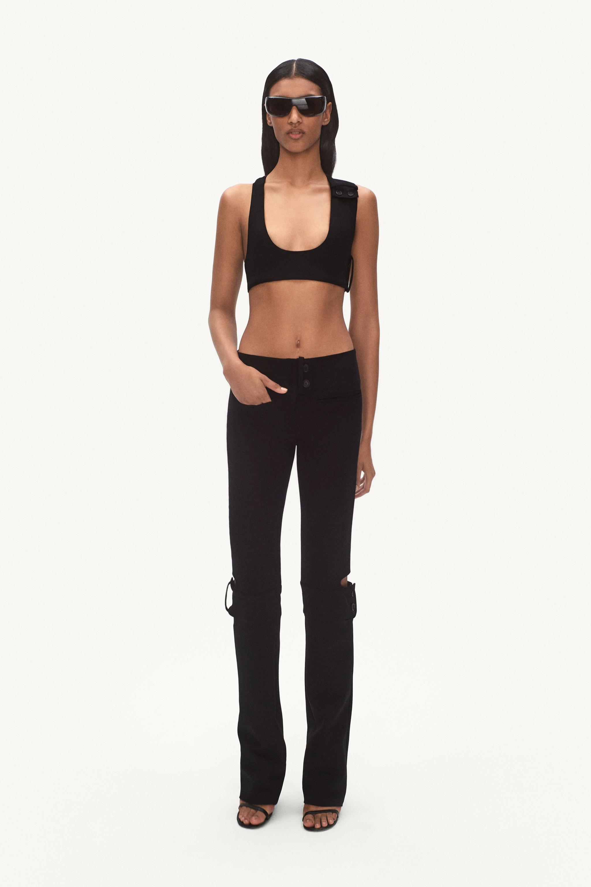 Elegant black crop top and pants by Courrèges, perfect for modern fashion styles.