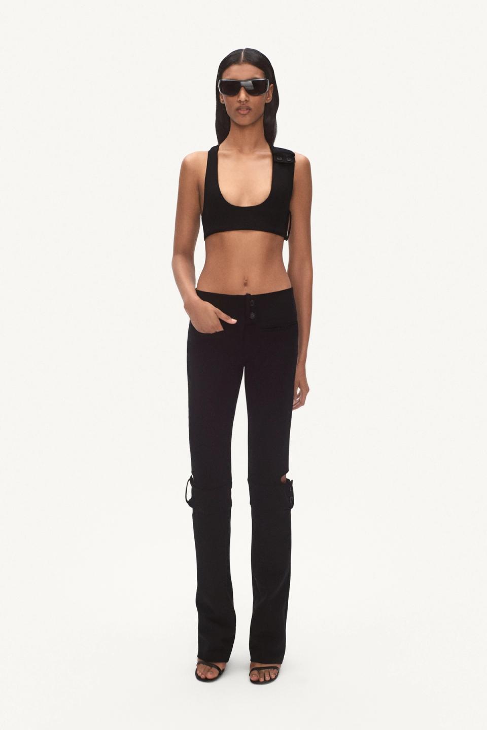 Elegant black crop top and pants from Courrèges, showcased on a fashion model for an ecommerce site.