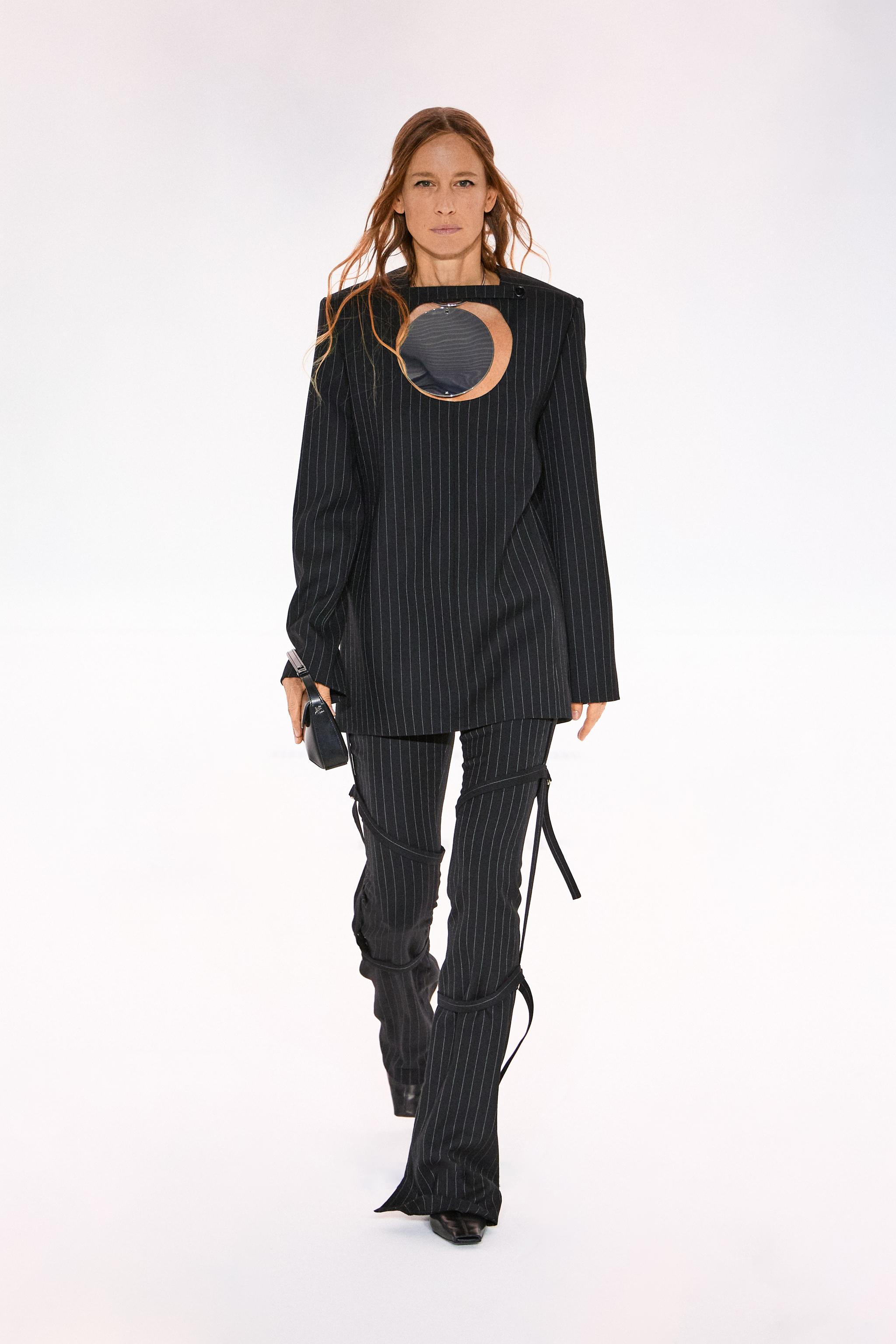 Elegant black pinstripe fashion outfit by Courrèges for modern, stylish women.