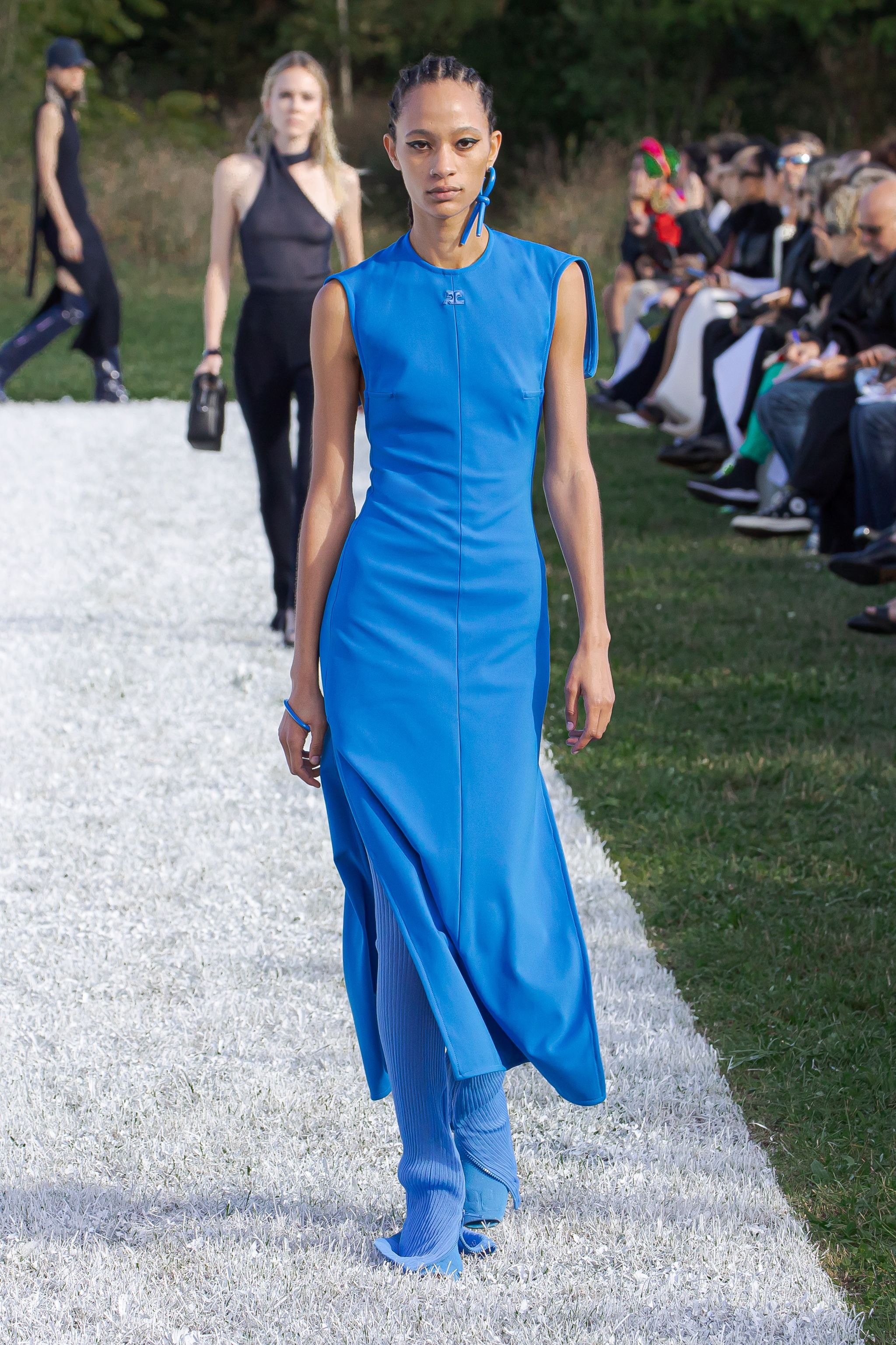 Elegant blue dress by Courrèges showcased on a runway, perfect for fashion lovers.