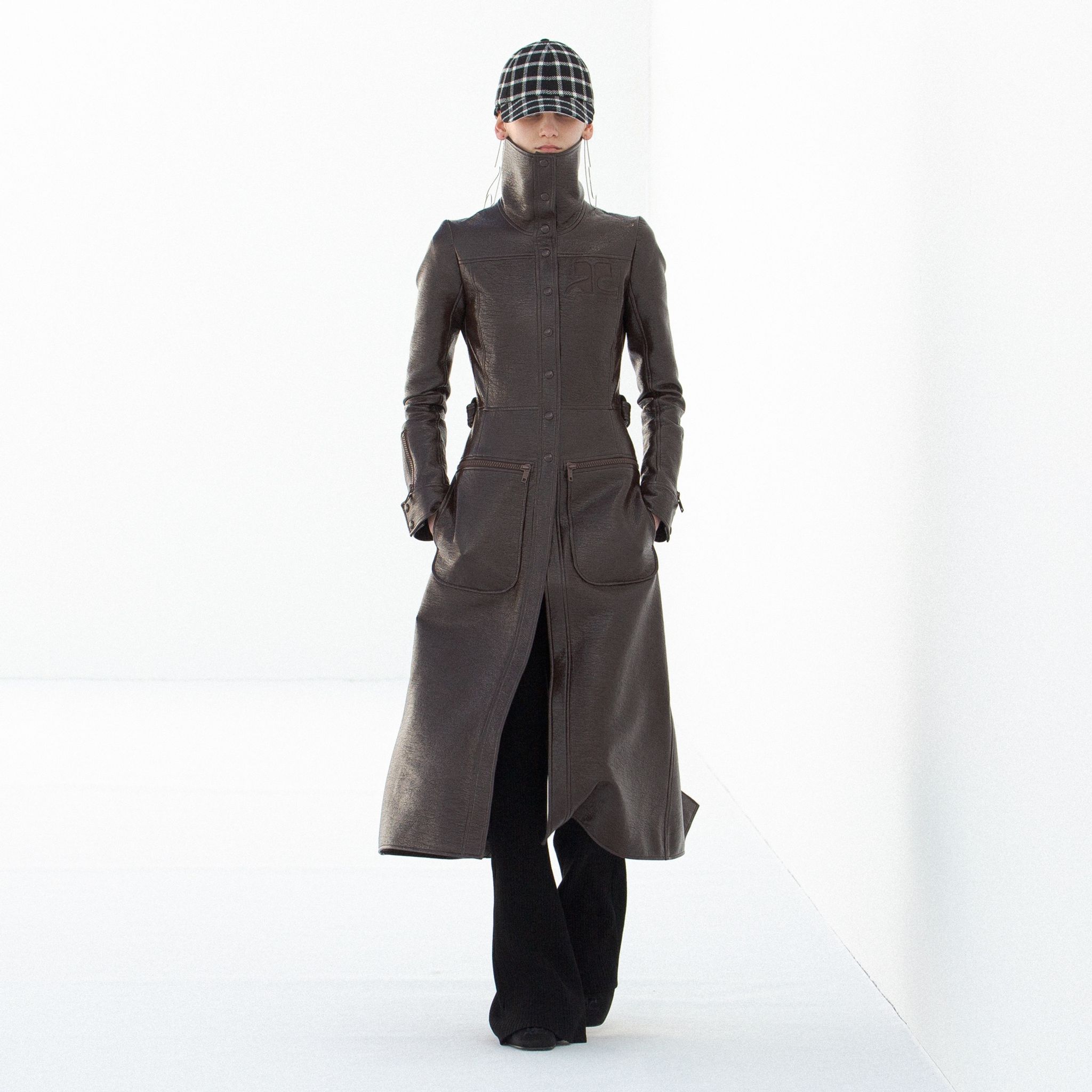 Elegant leather trench coat by Courrèges, featuring a high collar and modern design.