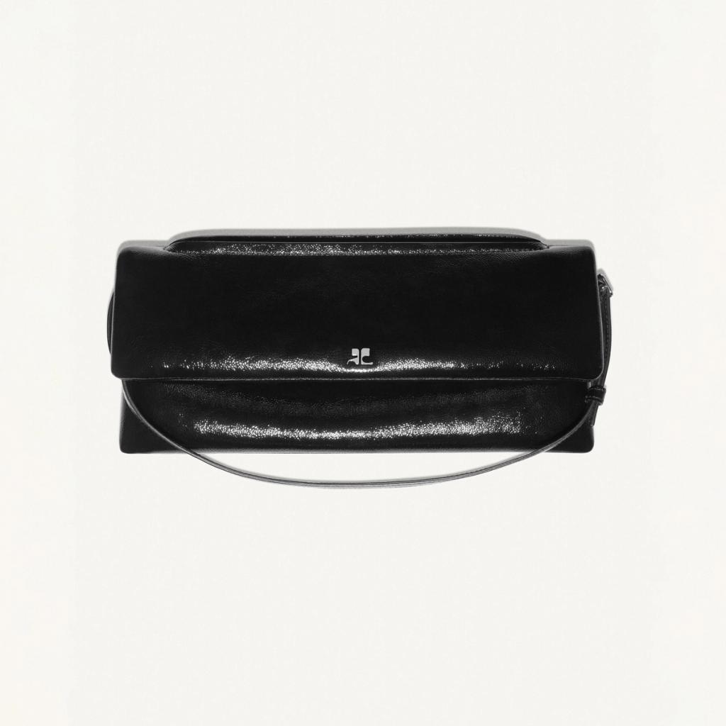 Elegant black glossy handbag by Courrèges, stylish accessory for fashion-forward looks.