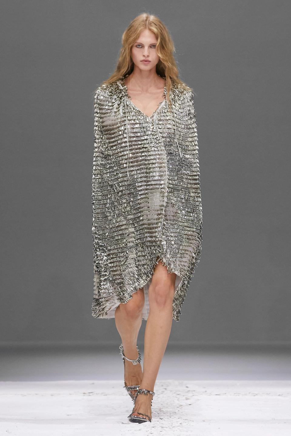 Elegant silver metallic dress with embellishments, runway fashion by Courrèges.