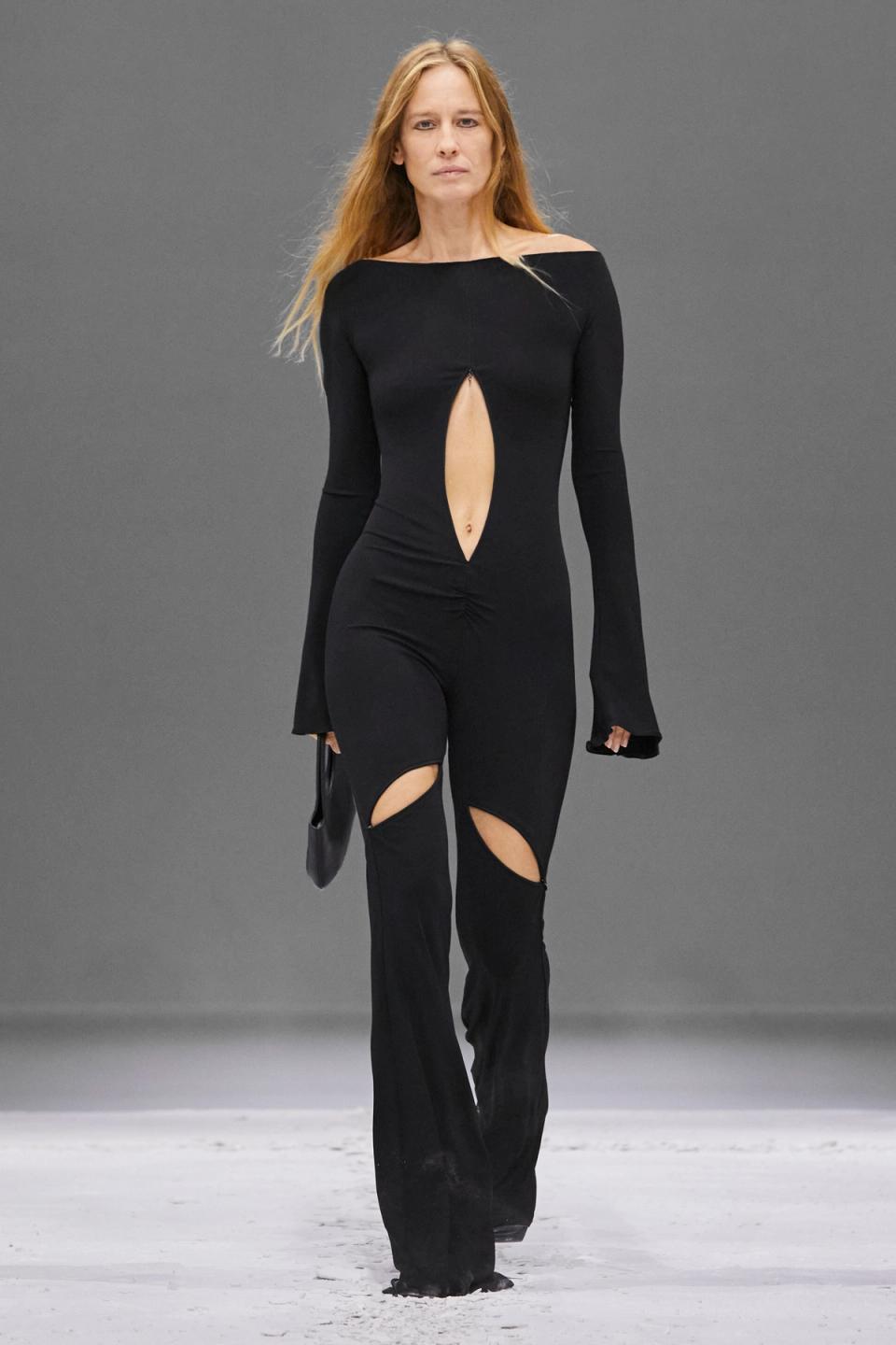 Elegant black jumpsuit with strategically placed cutouts, perfect for fashion-forward styling.
