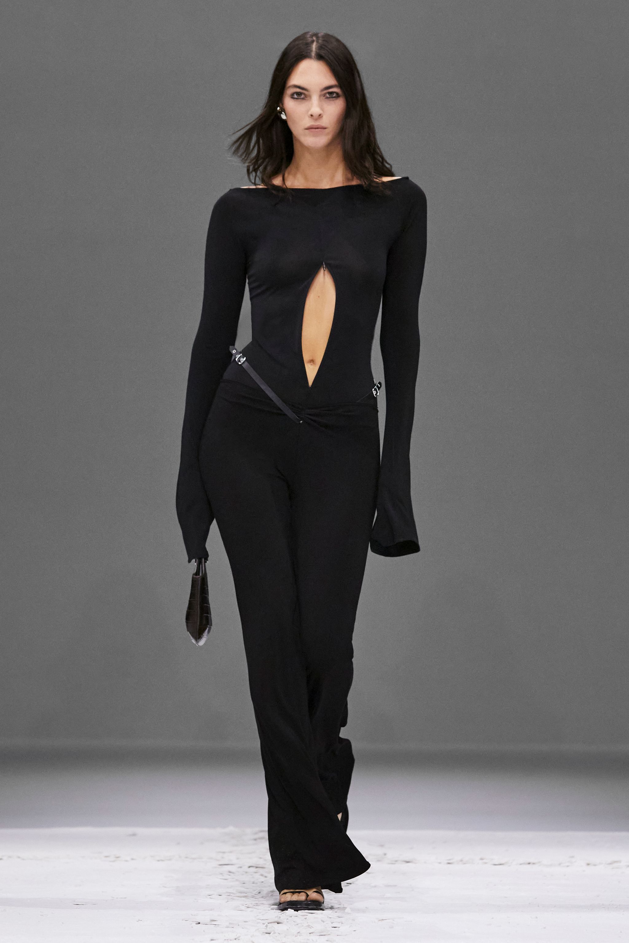 Elegant black Courrèges jumpsuit with a daring cutout, perfect for contemporary fashion shows.