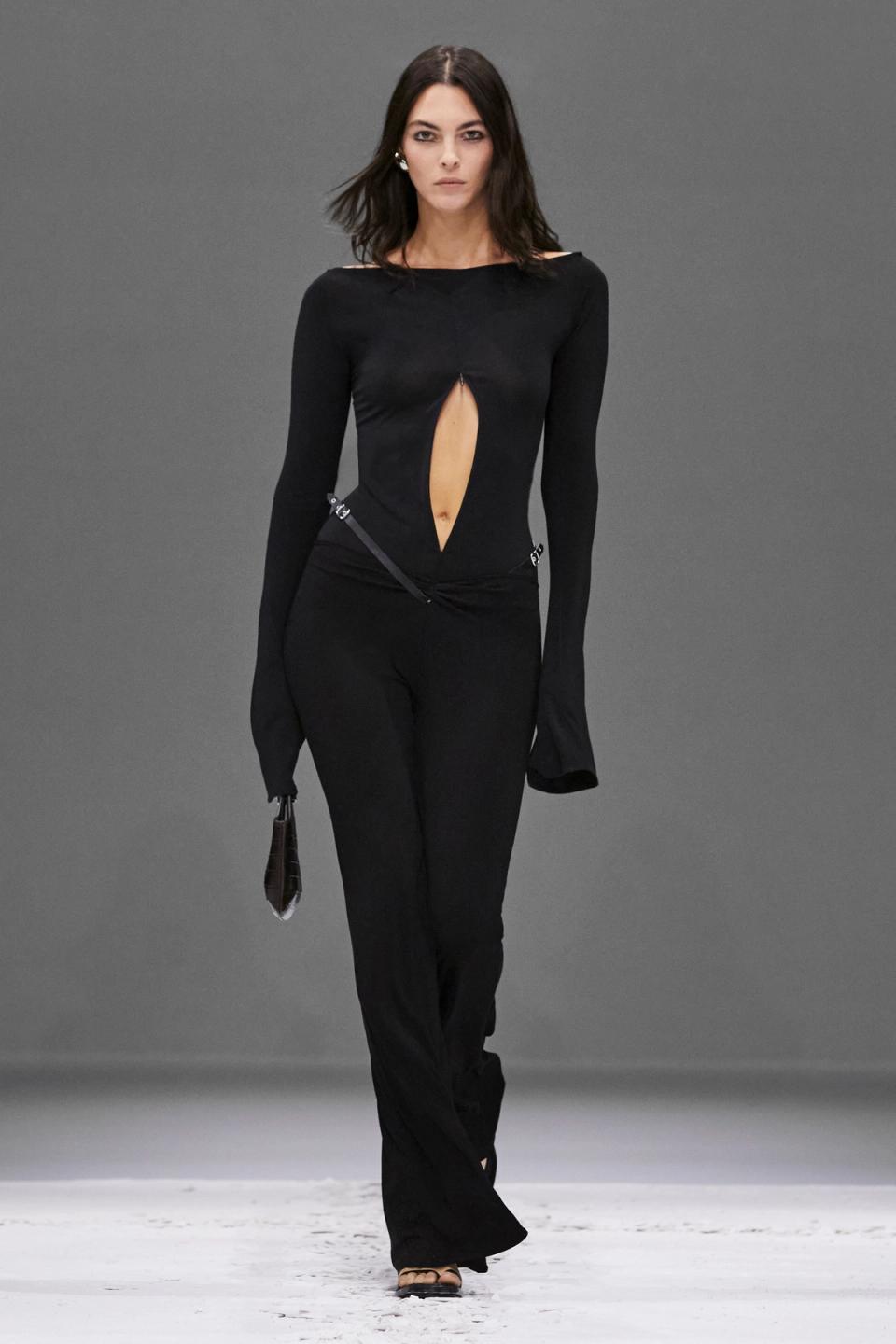 Elegant black Courrèges jumpsuit with a daring cutout, perfect for contemporary fashion shows.