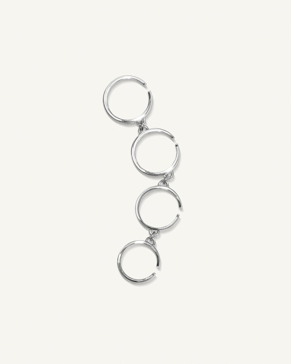 Elegant silver hoop earrings from Courrèges showcased on a white background, perfect for fashion lovers.