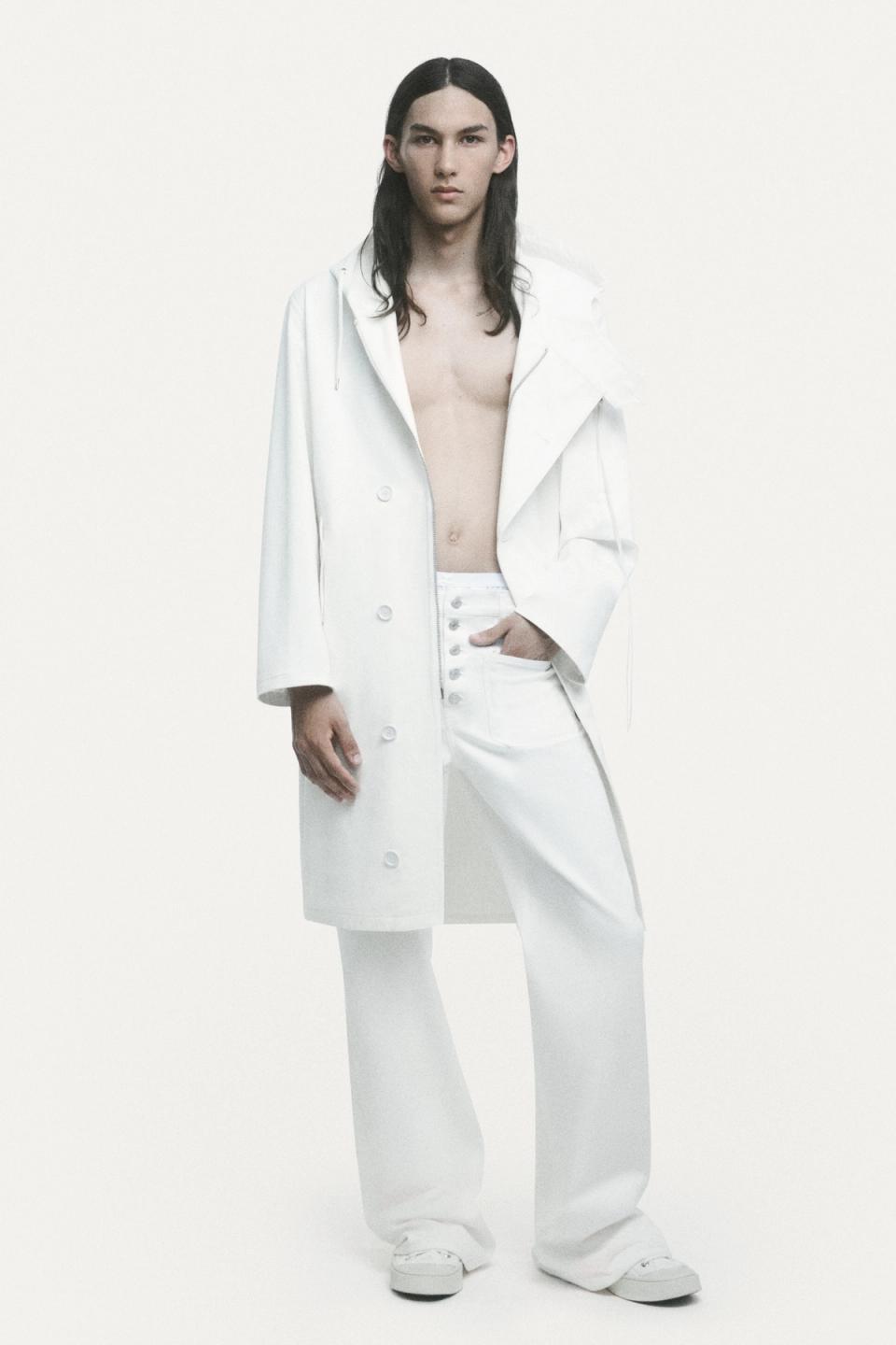 Elegant casual fashion featuring a white oversized sweater, layered with a denim skirt and wide-leg jeans, for Courrèges.
