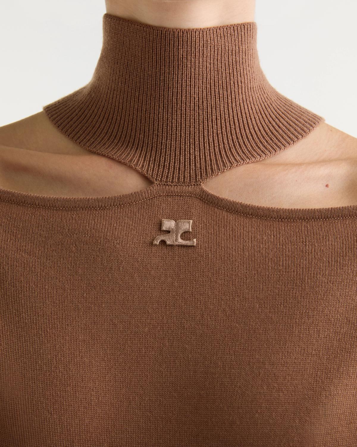 Close-up of a brown ribbed Courrèges knit top, highlighting its soft texture and signature logo detail.