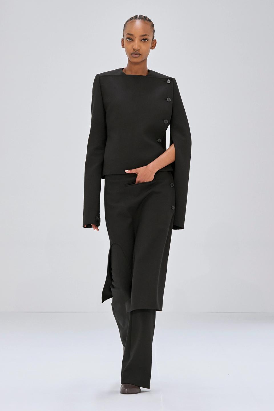 Elegant black tailored outerwear with asymmetrical button details, perfect for Courrèges fashion.