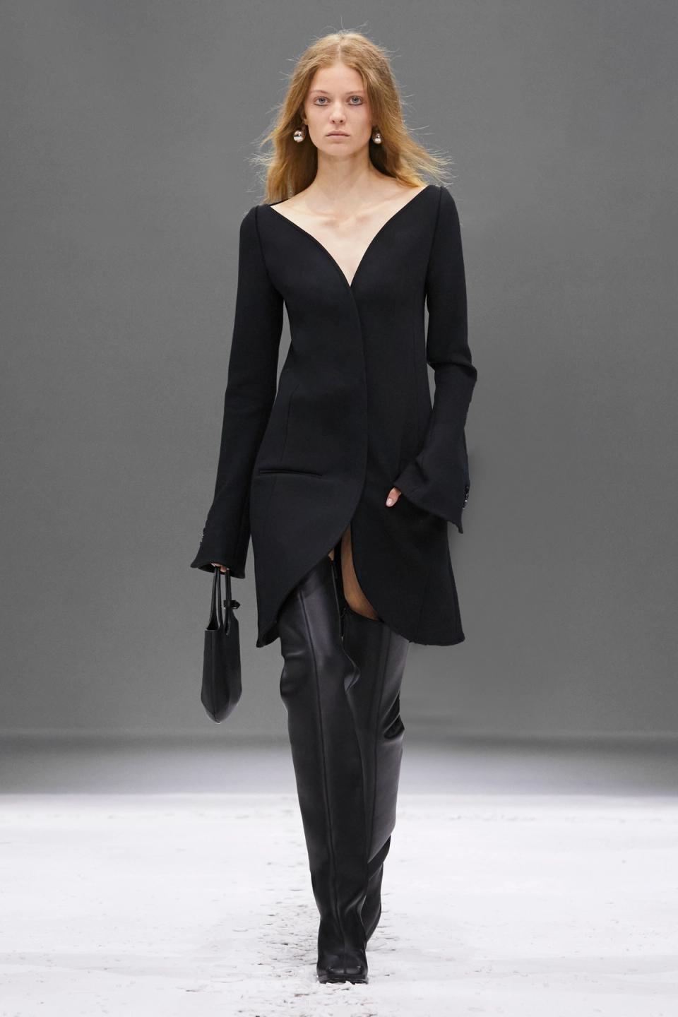 Elegant black dress and leather pants by Courrèges showcased on a fashion runway.