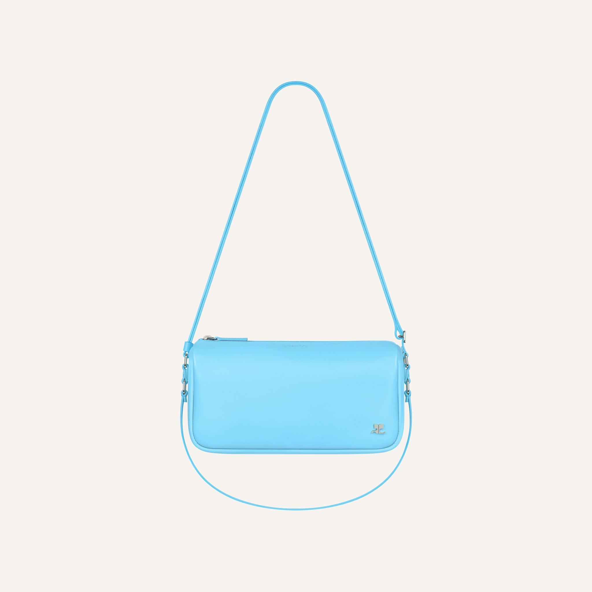 Elegant light blue Courrèges handbag with a sleek design, perfect for fashion-forward styling.