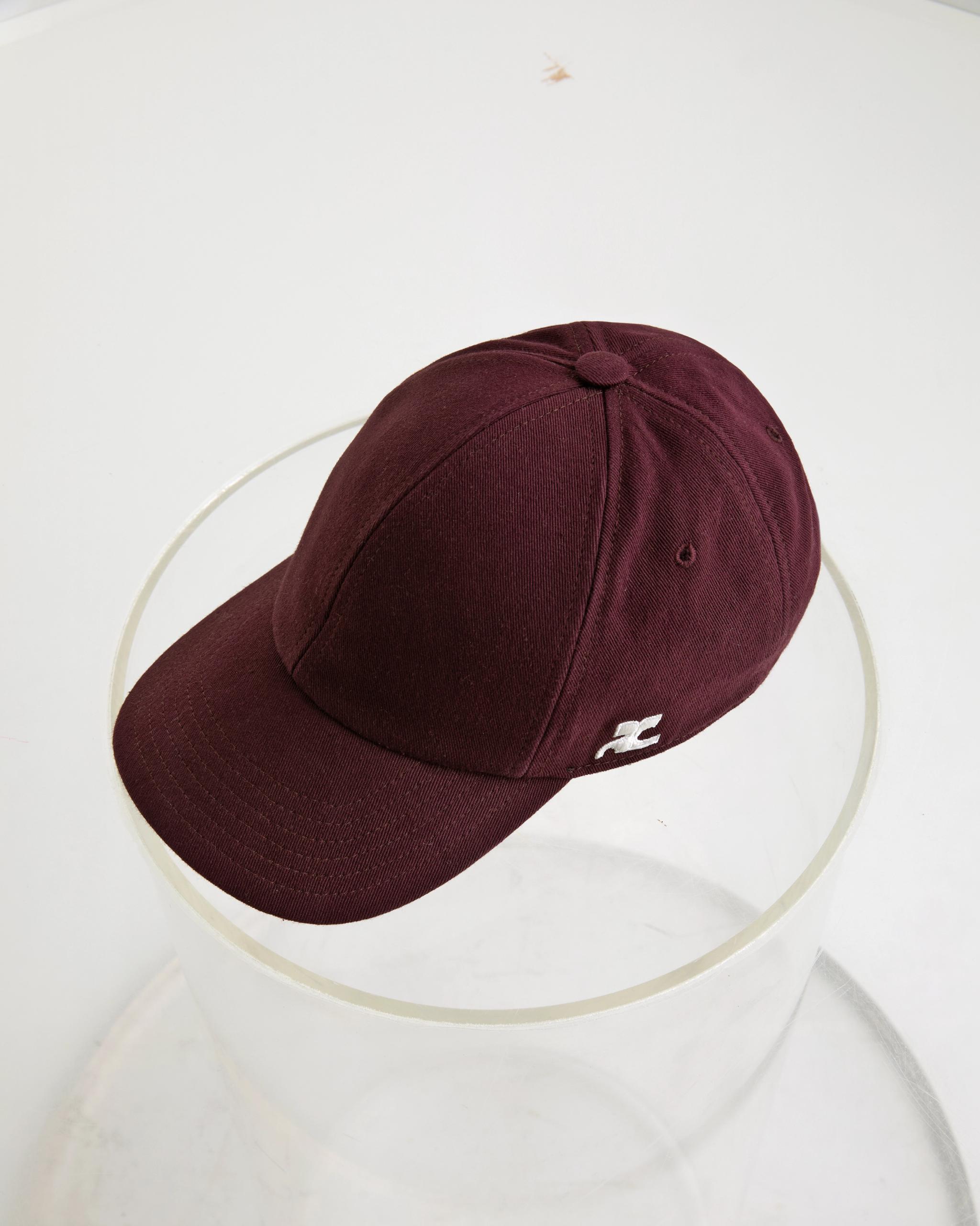 Elegant burgundy cap with subtle logo detail, perfect for Courrèges fashion style.