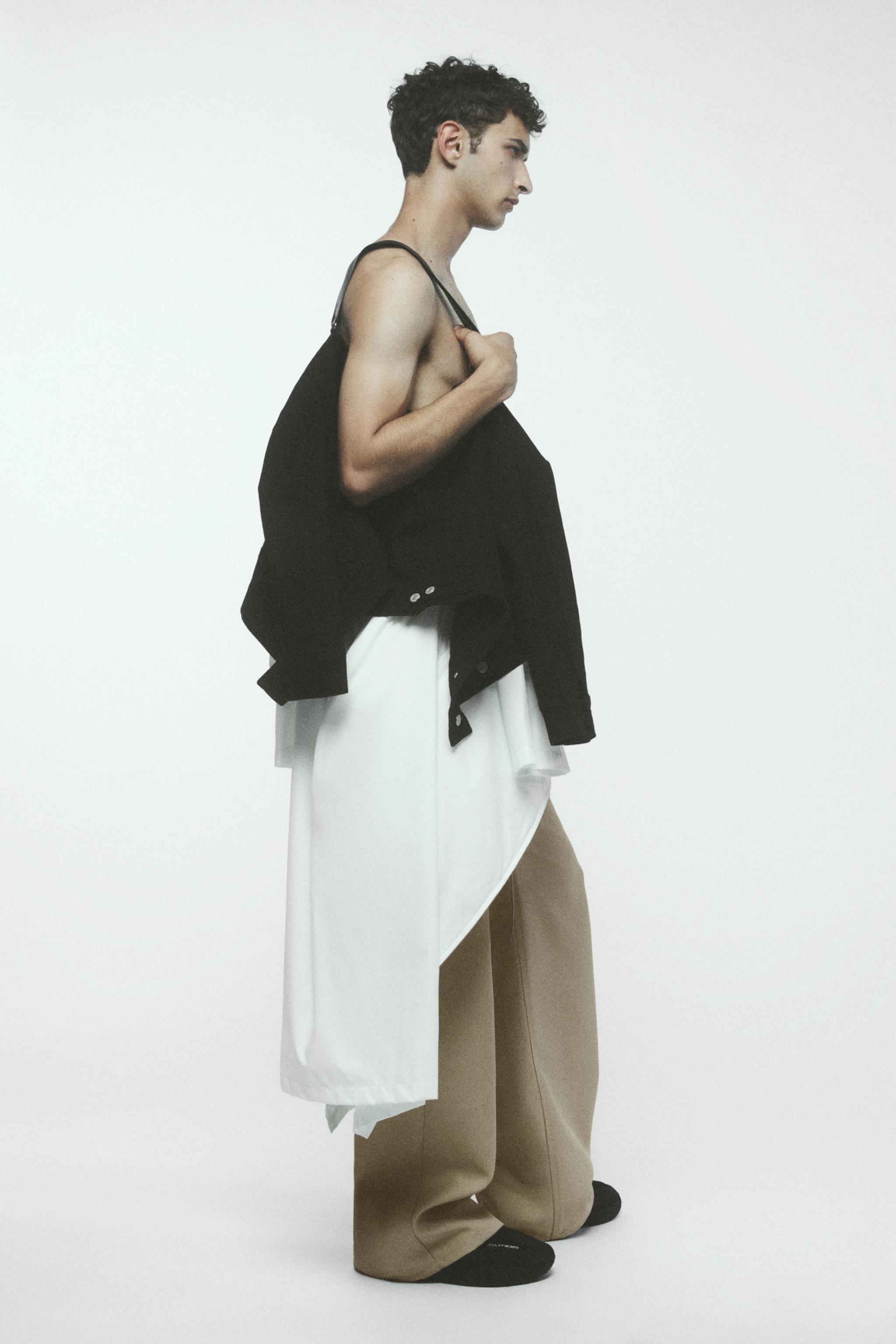Elegant model wearing layered fashion pieces by Courrèges, showcasing modern style.