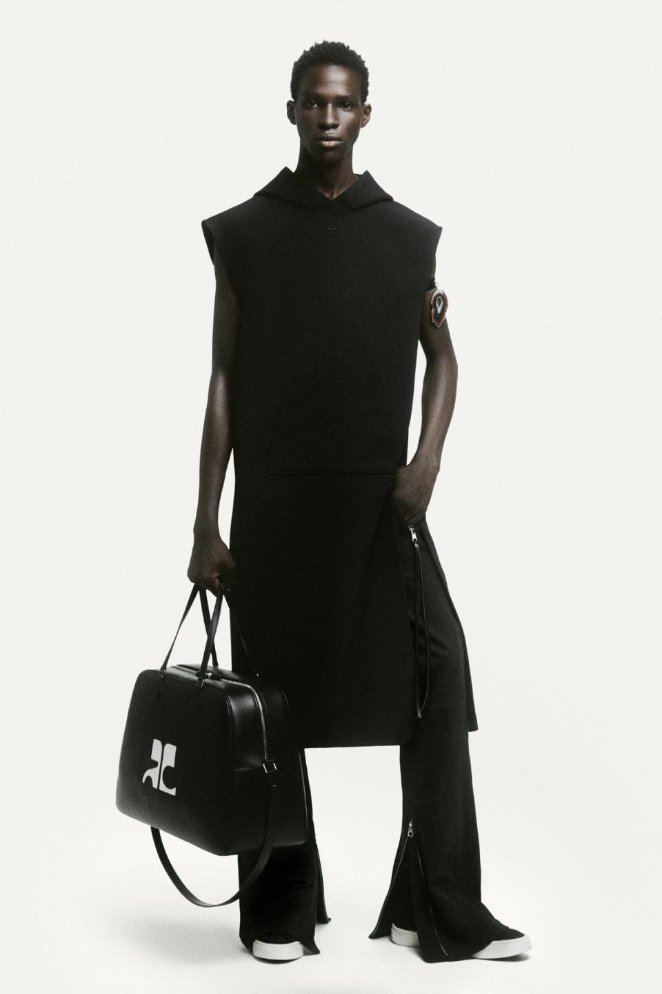Elegant, modern black Courrèges outfit featuring a sleeveless dress, oversized hoodie, and accessories.